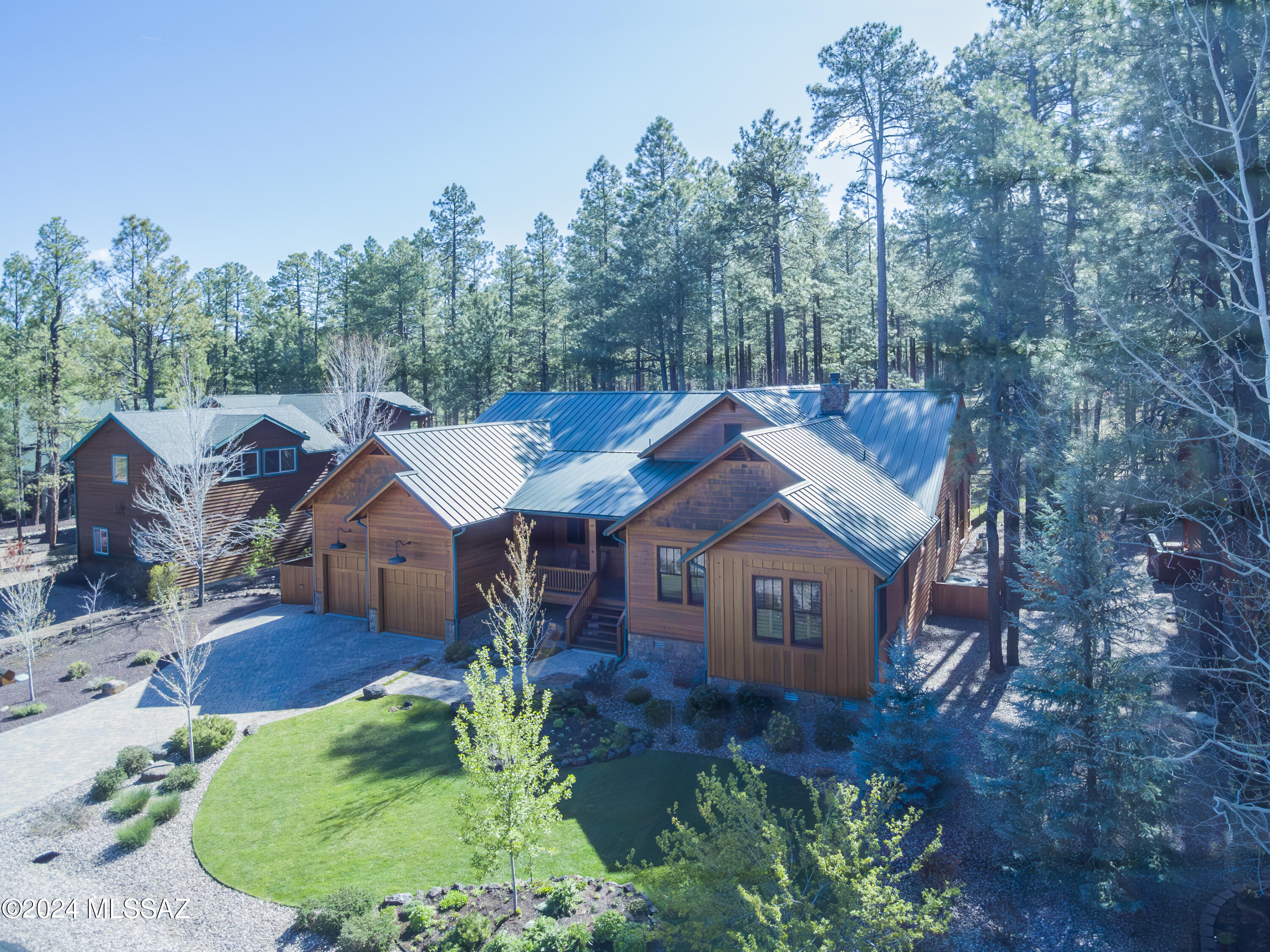 Bordering National Forest in the exclusive gated community of Starwood Estates, this meticulously designed single level custom built home awaits you. Enter the Great Room, past the walk-up wine bar, you are drawn to the serenity of the Forest seen through the wall of windows. Included are Aspen Tongue and Groove vaulted ceilings and hand scraped hardwood flooring. Stepping through the twelve foot doors to the back deck, entertainment awaits you with a gas fireplace and natural gas outlets for two grills. Adjoining the Great Room is the Gourmet Kitchen complete with ceiling height knotty alder cabinets, Wolf Gas cooktop, separate prep sink and wine refrigerator appointed around the cook's island topped with a single slab of Sandalus quartzite. There is a generous multipurpose room with laundry, sewing desk and craft tables along with a freezer and pantry space. Three bedroom, three bath home with an office (could be a 4th bedroom), two of the bedrooms are en-suites with gas fireplaces and provide access to the back deck where you can enjoy your morning coffee looking out over the forest. The Guest en-has an infrared sauna for you to indulge after outdoor activities. Knotty Alder shutters provide privacy throughout. Paver Driveway with an almost 700 square foot two car garage which includes a workshop area. Amenities include on-demand tankless water heater with recirculating pump, two gas pack heaters and A/C units, 22KW Generac natural gas generator w/automatic switching. A serene retreat with the highest quality finishes and unparalleled natural beauty. Listing Agent must accompany all showings.