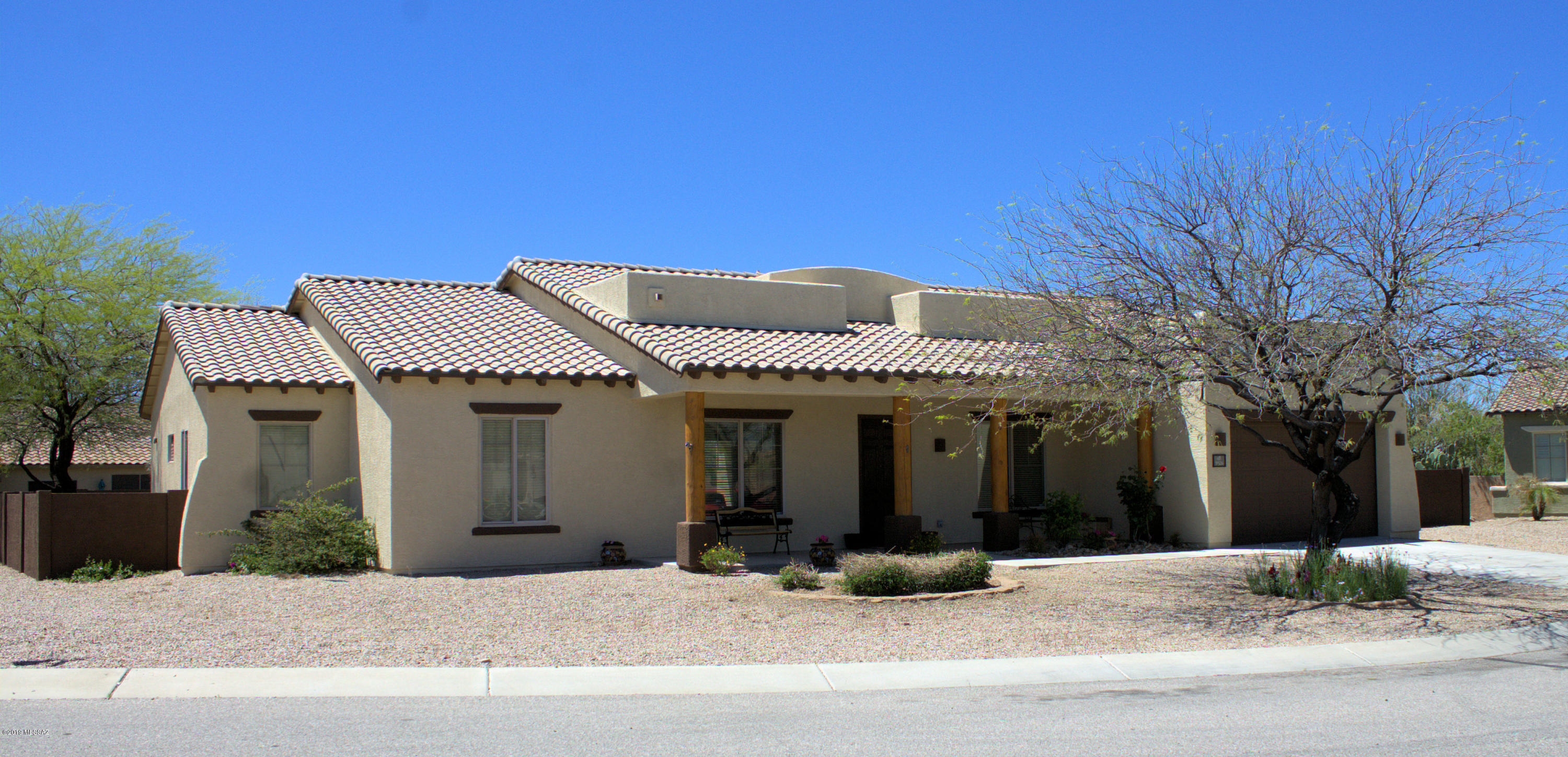 Welcome Home to this Pulte built wonderful home!  This single level home host 4 spacious bedrooms, 2 full baths and a half bath, formal dining room, office, great room with gas fireplace, large kitchen with breakfast bar and eat-in kitchen area, granite counters, high ceilings, Large covered patio and extended uncovered patio, established landscape with raised gardens, all located on a corner lot that is 17,849 sq ft and with a 2.5 tandum stall garage (33.5' deep). This Beautiful home also host a Ranch Style front porch looking North to the Catalina Mountains with the North / South Exposures. Freshly painted exterior and large open yard!  You have plenty of space for playing or adding a pool!  At this price you can add your extra garage for all those toys!