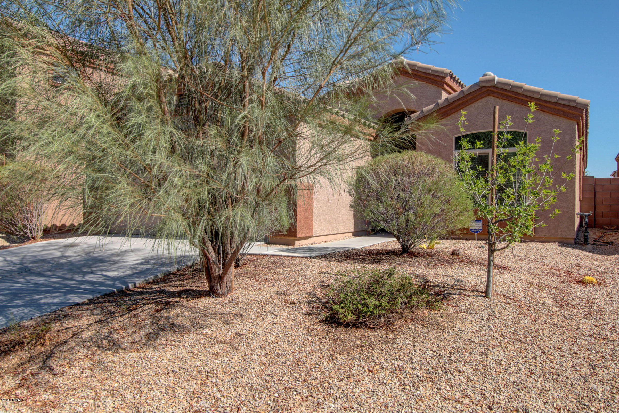 Welcome home to this stylish contemporary home with a den in Valencia Reserve South. Nicely upgraded DR Horton single level home including: birch cabinets, high definition “stone look” counter tops, ceramic tile, carpet, vaulted ceilings in the master bedroom, living room and kitchen.  Ceiling fans throughout, leased solar panels and energy star rated home.  Large Master bedroom has huge walk-in closet and privacy from the rest of the house.  Neighborhood has a community park, multiple grass pocket dog-walk locations, a perimeter walking or jogging path, community swings, basketball court and more.  Quick access to the airport and minutes off of I-10 – close to the interstate without the noise and quick access to Davis Monthan AFB, Raytheon, schools and shopping! MOVE-IN Ready!!