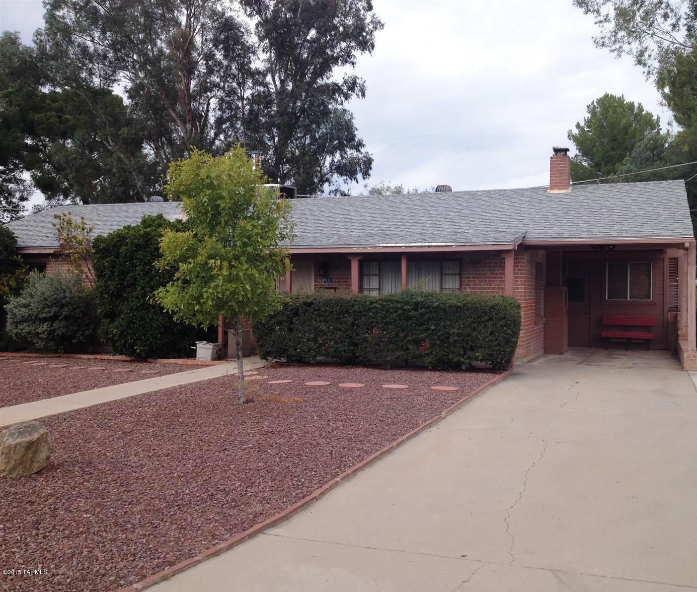 Beautiful brick home on private street with three large bedrooms. Spacious living and dining rooms, wonderful kitchen with refrigerator, gas stove, and dishwasher, tile counter tops and ample cabinet space. Updated bathrooms, and a large Arizona room with wood burning stove. This house has lots of storage space. New shingle roof with large capacity air conditioner. Great location for shopping, schools, and public transportation. Fenced back yard. Lovely home waiting for you.
