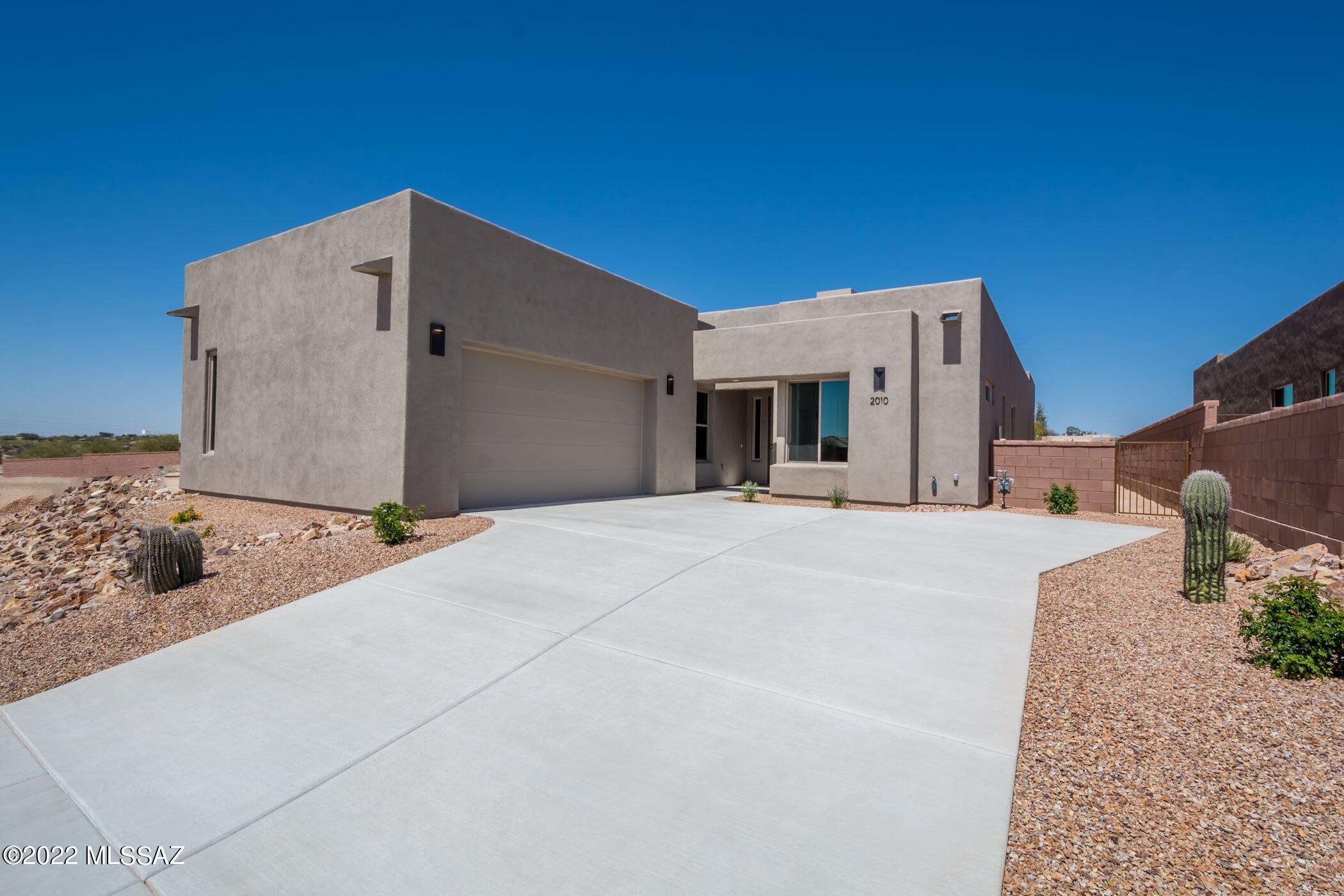 Be the first to own one of these luxurious new homes designed by renowned architect, Ron Robinette, in this spectacularly located gated community just north of Magee & La Cholla.  Features in this stunning contemporary home include fabulous greatroom with very cool floating drop ceiling, gorgeous tiled fireplace, huge gourmet island kitchen, stainless steel appliances, granite counters, tons of cabinetry and designer tile floors.  Other amenities include lovely master suite with generous walk-in closet,  dual sinks and beautifully tiled walk in shower;  6-panel doors and fabulous lighting fixtures throughout, exposed wood beam covered patio with great mountain views and side entry 2-car garage.   Home is nearing completion and will be ready for you to call home soon!