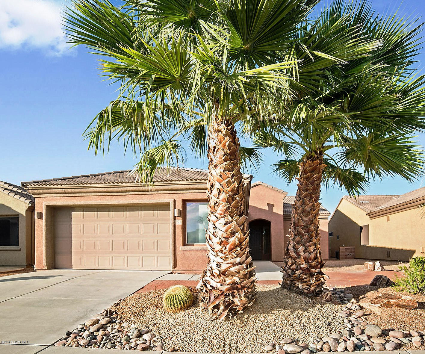 A beautiful home sitting high on a hill overlooking the Canoa Ranch Golf Course where you can also appreciate views of the Tucson Mountains miles away to the north. Two gorgeous palms trees sit next to a small paver patio that affords you outstanding views of the Santa Rita Mountain also! When you walk into the great room you will notice the desert toned floor tile, wide open floor plan and arched gateway passages. You will also find a cook's delight kitchen with an abundance of cabinets and countertops, double door pantry plus a convenient breakfast nook. The open area adjacent to the great room can be used for either a formal dining room or an office/den area. Your master suite is spacious and the bath features separate his and hers vanities and built-in makeup station. Oversized  2.5 car garage can accommodate a workshop or golf cart storage. Relax on your extended covered patio and enjoy expansive views in every direction! Furniture and furnishings are also available it you'd like - just move right in and start enjoying the Arizona lifestyle!