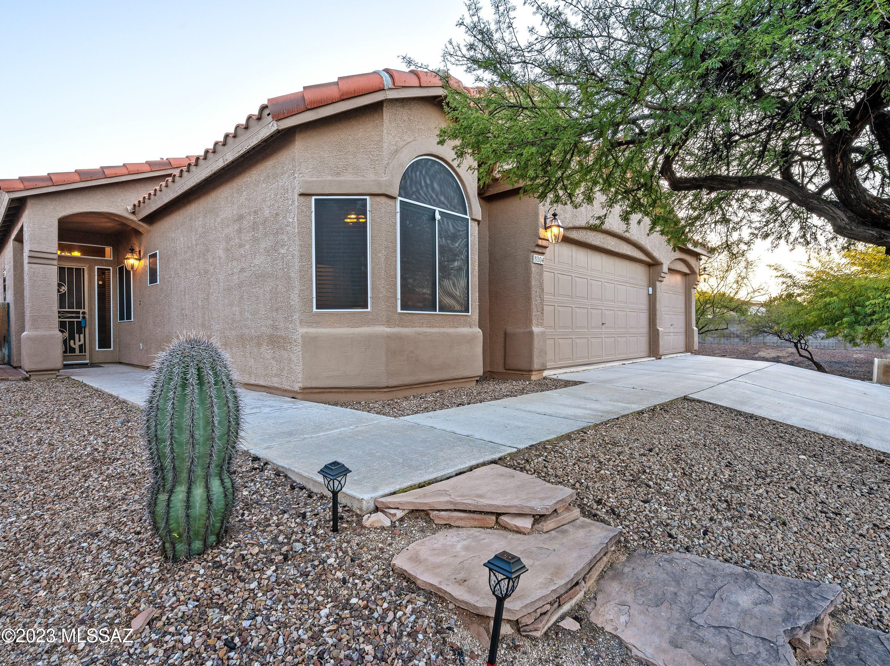 Welcome home to Rita Ranch! Tucked away on a corner lot, this home borders a lush canopy of mesquite trees. Walk inside to find an open-concept floor plan perfect for entertaining and family living. The kitchen boasts modern soft close cabinets which are offset with granite countertops and subway tile backsplash. Prepare your favorite meal on the natural gas range then enjoy in the dining nook or kitchen island. Your home has 4 bedrooms, split floor-plan, and a primary bedroom ensuite. You will have plenty of space in your 3-car garage with cabinets for storage and epoxy floors. Gather outside in your backyard to enjoy the green grass, mature trees and two beautiful patios. You are a short drive away from shopping, restaurants and the I-10. *Bonus* You're located within a state and nationally recognized school district- Vail School District.