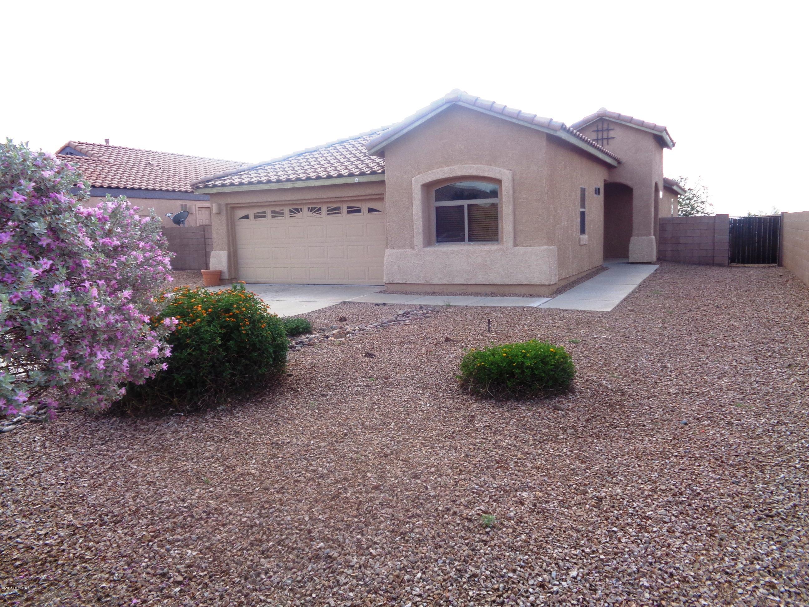 Fresh interior paint and new carpet in this popular great room floor plan home located on a quiet cul-de-sac. Huge great room with vaulted ceilings, ceiling fan  and surround sound. Kitchen open to the great room features a large island with breakfast bar, recessed & pendant lighting, gas oven/stove, refrigerator, washer, microwave and walk in pantry. Master suite features two closets, executive height vanity with dual sinks and a separate water closet. Guest bedrooms also have ceiling fans and high ceilings. Built in high display shelves throughout, some with outlets. Laundry washer & dryer included. Property backs to open desert common area with view fence for total privacy and mountain views. Covered patio. Putting green. Soft water loop in garage.