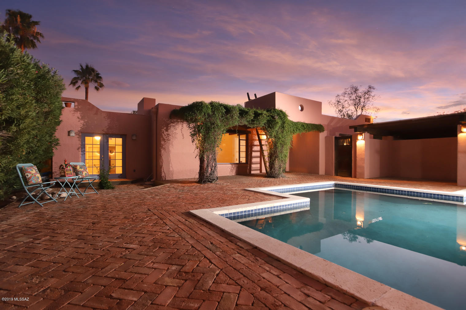 Beautiful & private Santa Fe Hacienda in Catalina Vista (Arizona Inn area). Old World Ambiance! Enter through the vintage wood gate to the beautiful, private, walled, front courtyard with its Pebble Tac Pool, fountain and lounging area. The covered front entry & patio leads to the 25' x14' beamed ceiling, living room with a fireplace & window wall view of the court yard. The comfortable, 12' x 21', Family rm/Den leads to the 31' x 10' Dining/Arizona rm which opens to a covered patio off the rear yard. The large master suite has an additional br & office/exercise rm. Above the home's front entry is a roof top bench & viewing area with Catalina Mtn views.The large, rear yard offers many possibilities. A great home for family gatherings & entertaining. Interior water lines & gas line to the