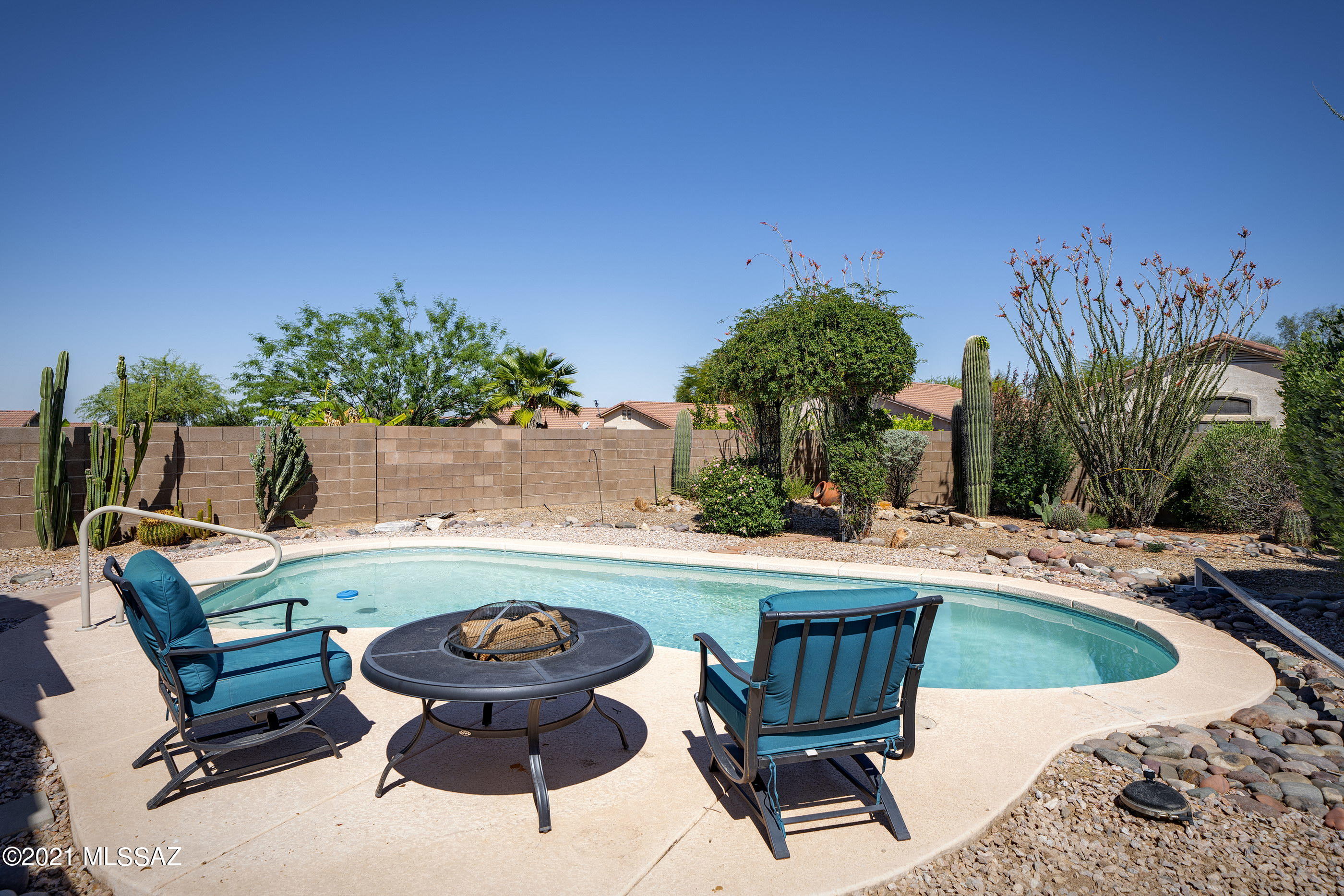 Enjoy this well-maintained home in the desirable Villages at Dove Mountain! As you walk in, be greeted by the spacious great room with gas fireplace that opens up to the kitchen and dining area. The kitchen is designed for a chef at heart with plenty of counter space, black appliances, pantry and freshly painted cabinetry. The master retreat features a walk-in closet, soaking tub, and separate shower. 2 additional guest bedrooms are sequestered on the south end of the home with another full bath and an additional bedroom/den/flex space off the great room. Relax under the expansive covered patio and walk out on the flagstone to soak up the sun in the large pool. The community offers a large park, tennis courts, dog parks and numerous hiking trails.
