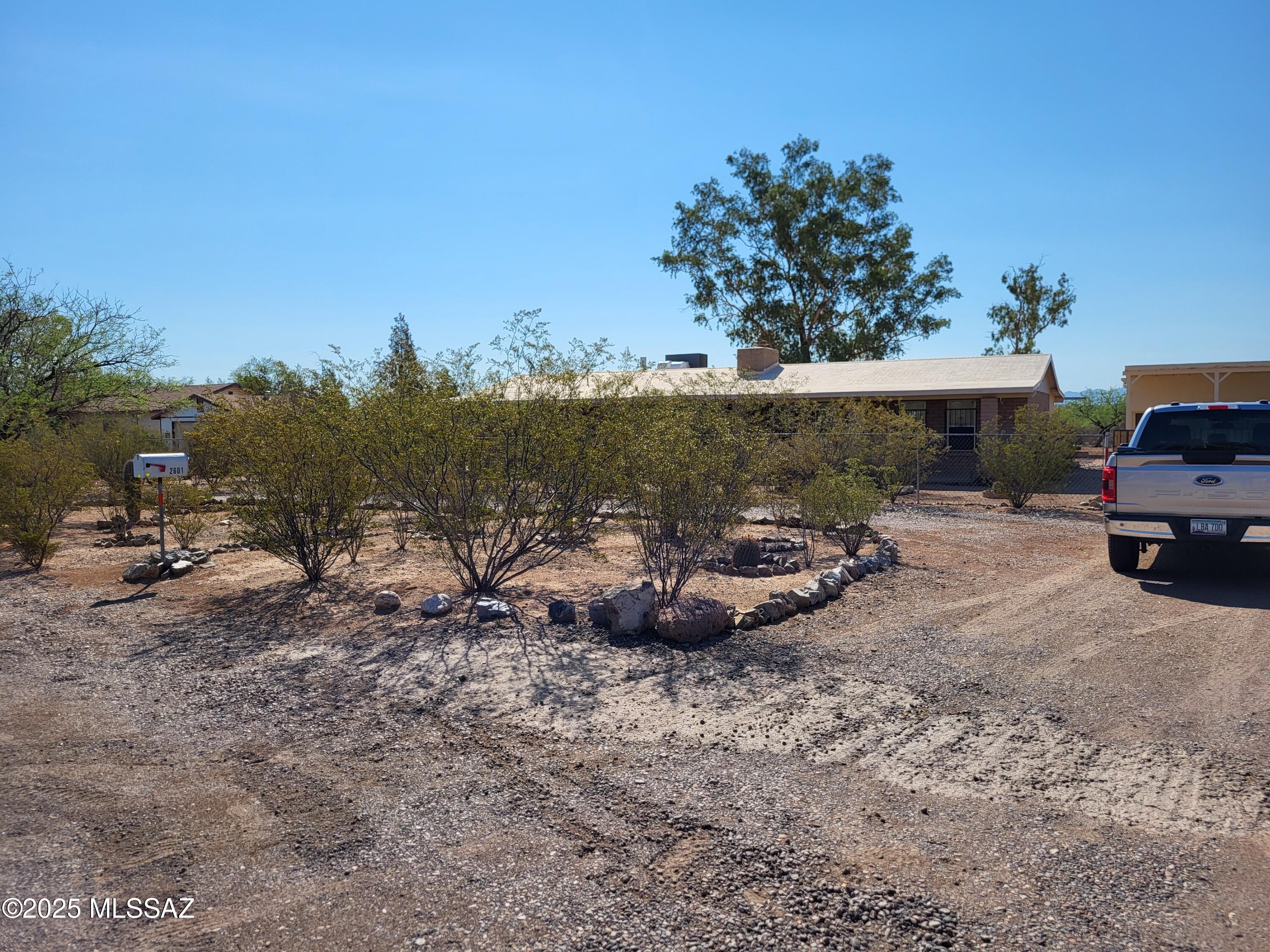This is a great property! Masonry constructed ranch style house with a split bedroom floor plan, spacious and open living area and a two sided fireplace. 1.2 acres that borders the Indian Reservation and federal land with unobstructed views. Horses allowed, no facilities. The property includes a detached three bay carport larger enough for RV parking with a RV hook up and a workshop. An additional detached building with one room set up for living quarters and a workshop/hobby room.