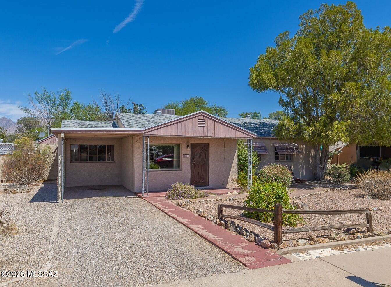 Excellent opportunity in Central Tucson's charming Pima Verde Subdivision. Classic Mid-Century neighborhood conveniently located near TMC, DMAFB and University of Arizona. Set on a generously sized Lot (nearly 9000 sq ft) this property has plenty of room for everything and no HOA! Versatile Floorplan with 3 Bedrooms plus 2 Living Rooms + large utility room w/ additional half bathroom. 2nd Living Room/Utility Room/Half Bath could possibly convert to Primary Suite??Charming interior w/ many original finishes, including Kitchen & Main Bathroom. Seller made some recent improvements, including NEW ROOF in 2024. Spacious North facing rear patio & oversized backyard full of mature trees & peak mountain views. Plenty of room for parking, including 1 Carport space. Property Sold ''As Is''.