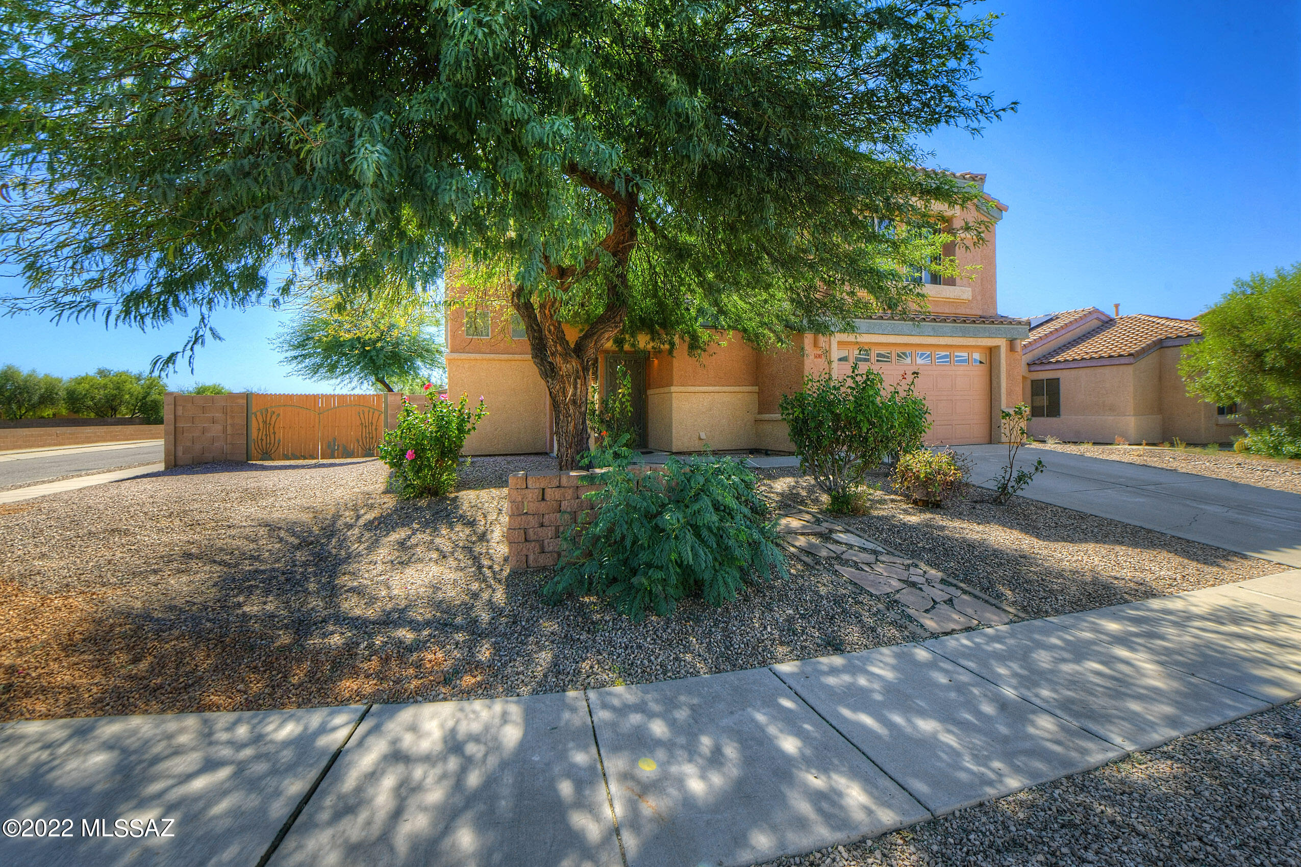 Sellers Are Still Showing Property And Accepting Back Up Offers. Seller will accept or counter offers between 375,000-400,000K. Located in the desirable Camino Estates this beautiful 4 bedroom/2.5 bath home is sure to please!This 2005 Lennar home was built on a premium corner lot with green belt behind, so there is only one neighbor! Privacy and Serenity from your home and backyard, complete with Mountain Views.
Step inside this home that is in better than new condition. The fully functional kitchen has plenty of workspace and has been upgraded with granite counter tops, black appliances, pull outs, recessed lighting, and breakfast bar. The kitchen overlooks the Great room with wood look tile flooring and a built in Entertainment center. The sliding door and windows have custom wood shutters, and the ceilings are cathedral height with plant shelves for your artwork or decorations. Conveniently located downstairs we have the Owners suite. Wood look tile flooring and ceiling fan in this generous sized room. Walk through to your ensuite bath including double vanity with executive height counter tops, separate shower, soaking tub, private water closet and an oversized walk in closet. The mounted TV conveys with the property. When entertaining there is a powder room with a pedestal sink located next to the front door for your guests. Larger size laundry with cabinets will lead you into the double garage that has epoxy flooring and with storage cabinets. 
(Head upstairs and you will see the beautiful picture windows on the landing. There is a full desk located at the top of the stairs which is great for homework or a home office. Three amply sized guest bedrooms all with slider closets and ceiling fans. Guest bathroom upstairs has shower and tub. Back downstairs head outside onto the covered patio to your own Backyard Entertainment Area. This magnificent landscaped backyard has an oversized custom gazebo with lighting, ceiling fan, table and benches. With no rear neighbors this is the perfect place to enjoy Tucson sunsets and mountain views with your friends and family. The custom waterfall and decorative rock complete this already gorgeous backyard. There is a storage shed with electricity which is perfect for storage, man cave or she shed. Also custom double gate for easy access to the backyard or additional parking. Located in the Southwest area of Tucson, it is conveniently close to Schools, Restaurants, Casinos, Shopping, Medical, Airport and so much more. Make an appointment to see this today!