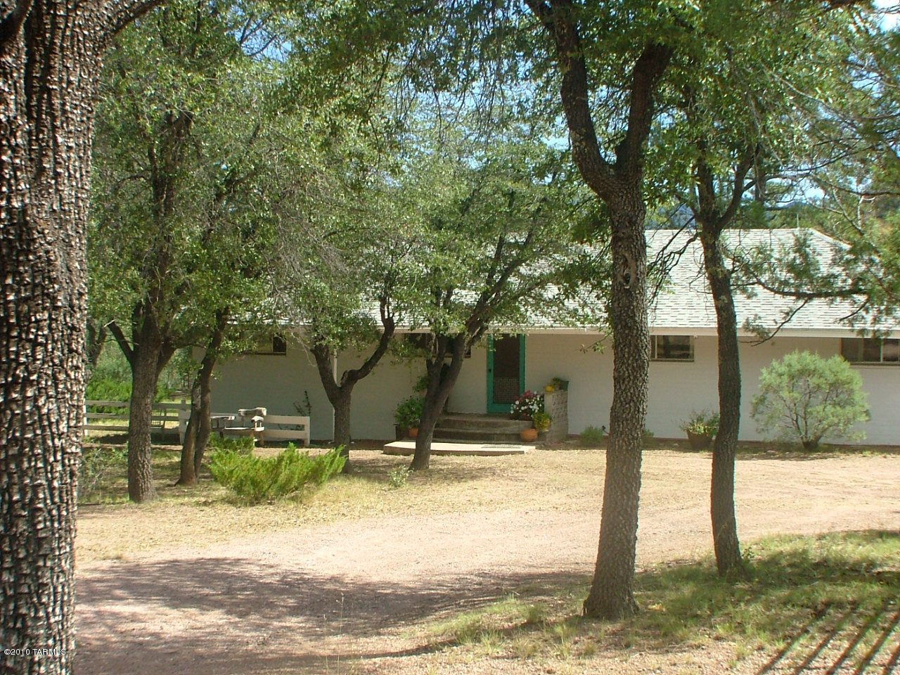 PRICE REDUCTION - Nature lovers paradise! Enjoy end-of- the-road privacy in this charming 2144sf 3BR/3BA country retreat tucked into the oaks and pines of the Canelo Hills, located approx. 20 min. S of Sonoita and near Parker Canyon Lake. The property sports a garage, swimming pool & open deck surrounded by mature shady trees. Two outbuildings could easily convert to accommodate garden, workshop, or barn for your horses. The forest border provides for birding, hiking, and  riding trails,  making this the  perfect vacation, weekend or full-time ''getaway''!!