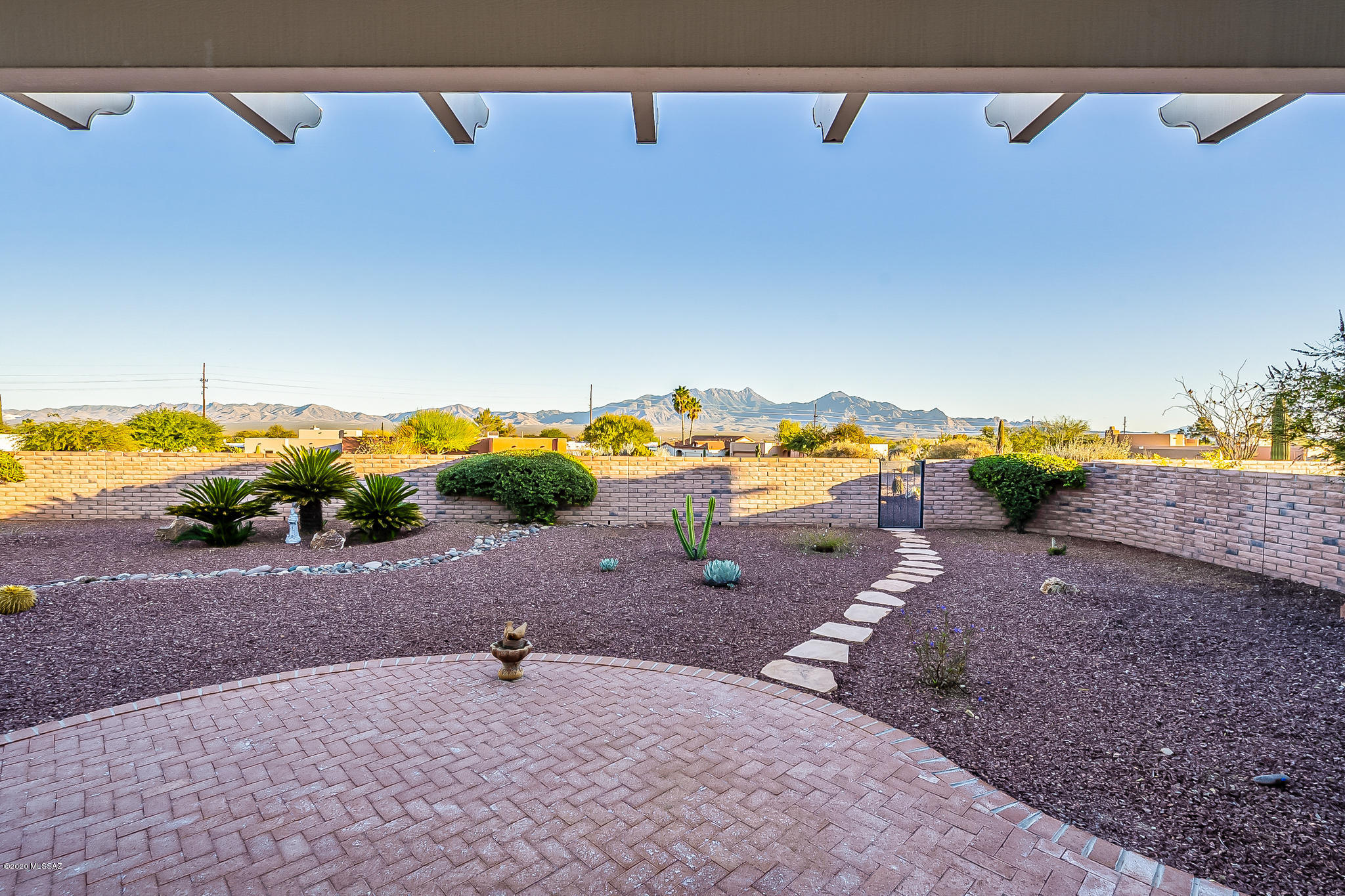 You will be WOWED the moment you enter this home. Pride of ownership shows in this 2113 sq ft custom Pierce built home. 3 bed/2bath/Den an extended 3 car garage nestled on a very large lot in Portillo Ridge with astounding mountain views! The original owners have meticulously maintained this home from top to bottom.  As you walk in you will notice the 18'' tile laid on the diagonal throughout and the extra large windows in the great room that show case the fantastic mountain views. New Anderson windows, Plantation shutters throughout, New heating/cooling system with a whole house humidifier, air purifier and a fresh air ventilator, Prepaid solar lease, smart thermostat. Too many upgrades to mention here a list is provided. The open kitchen boast 42'' cabinets w/ soffits & bottom pull outs, newer SS appliances, 2 pantries, double sided island, water purifier, and an eat up breakfast bar. A separate dining area that leads to the screened in patio where you'll enjoy the mornings and evenings taking in the incredible panoramic mountain views. The extra large master bedroom has larger windows and a walk in closet. The master bathroom contains a separate walk in shower, double vanity, solar tube, extra quiet exhaust fan and much more. Guest will appreciate their privacy with the split bedroom floor plan and enjoy the covered private patio connected to the guest bedroom. Laundry room has plenty of cabinets for storage and a utility sink. The extended 3 car garage with epoxy floors, air conditioning in work shop area is a nice added touch to this beautiful home. Make an appointment to view today. You won't be disappointed!