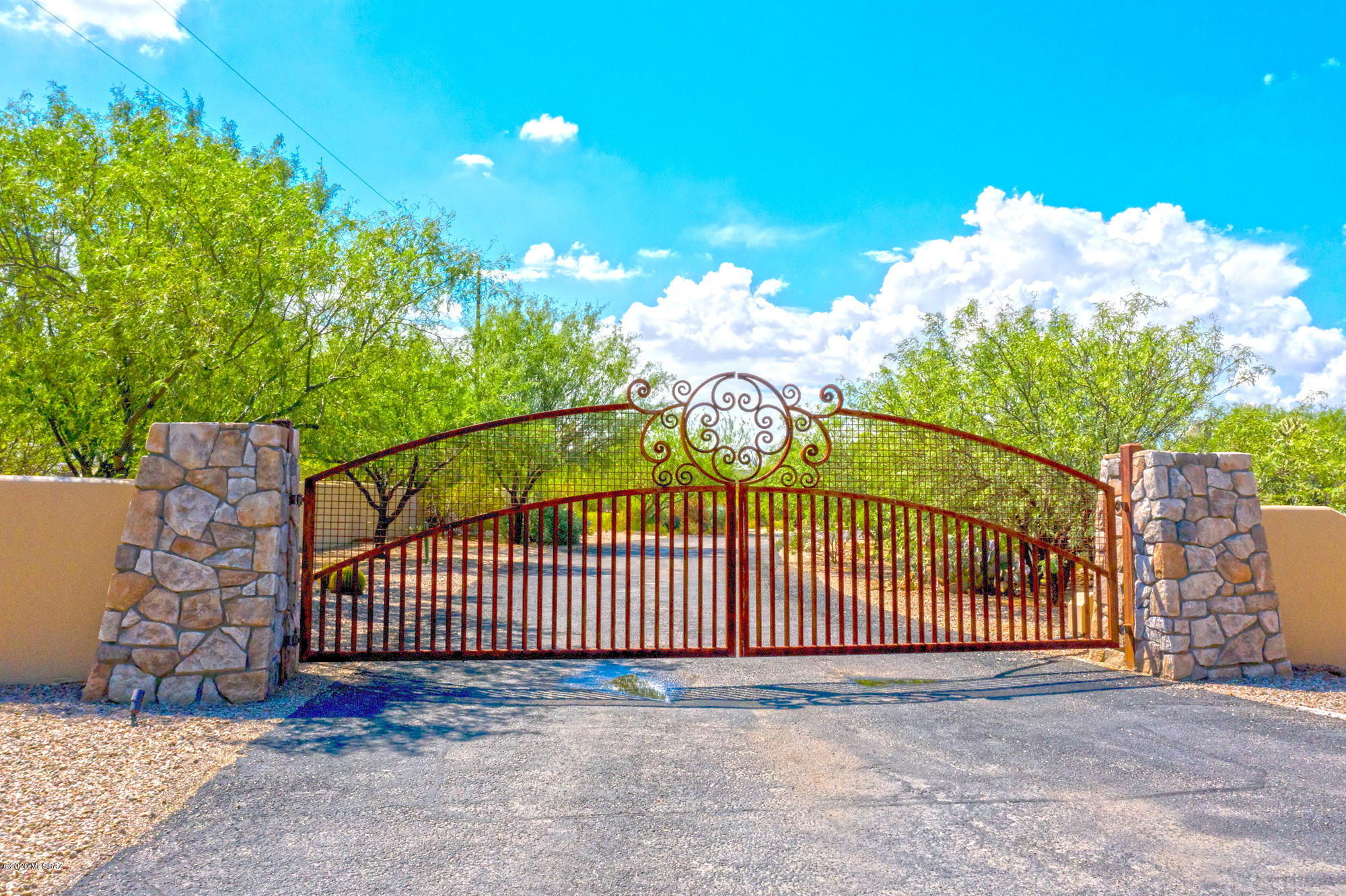 The gated community of El Rancho Merlita tucked away in a lush mesquite grove of the Tanque Verde Valley. There are eight custom home lots available for sale in this subdivision of 16.  Lot # 1