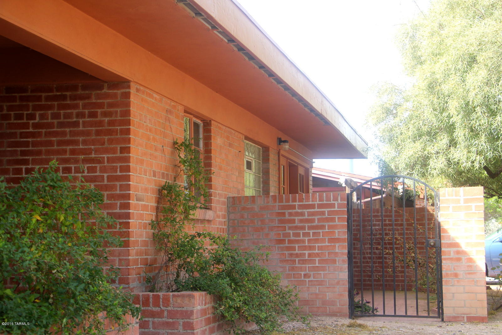 Don't miss this one. Wonderful brick ranch in desirable Encanto Park! If your search includes being on the bikepath to UA, a great walkscore and Sam Hughes elementary, look no further.  How about 3 bedrooms and 3 baths?!  This solid midcentury home may be just what you've been waiting for!  Affordable and ready for you to make it your own. With a little love, this will really shine!  Backyard is massive and a bit of a blank slate, though is walled, gated, and there's a huge covered patio. Small patio in front too, for morning coffee...or make this your guests' room and private courtyard.  This neighborhood, just east of Sam Hughes, puts you just blocks from Whole Foods, the Loft, and right on the 3rd St bikepath to UA main campus.  Great home for a family, incoming professors, or students.