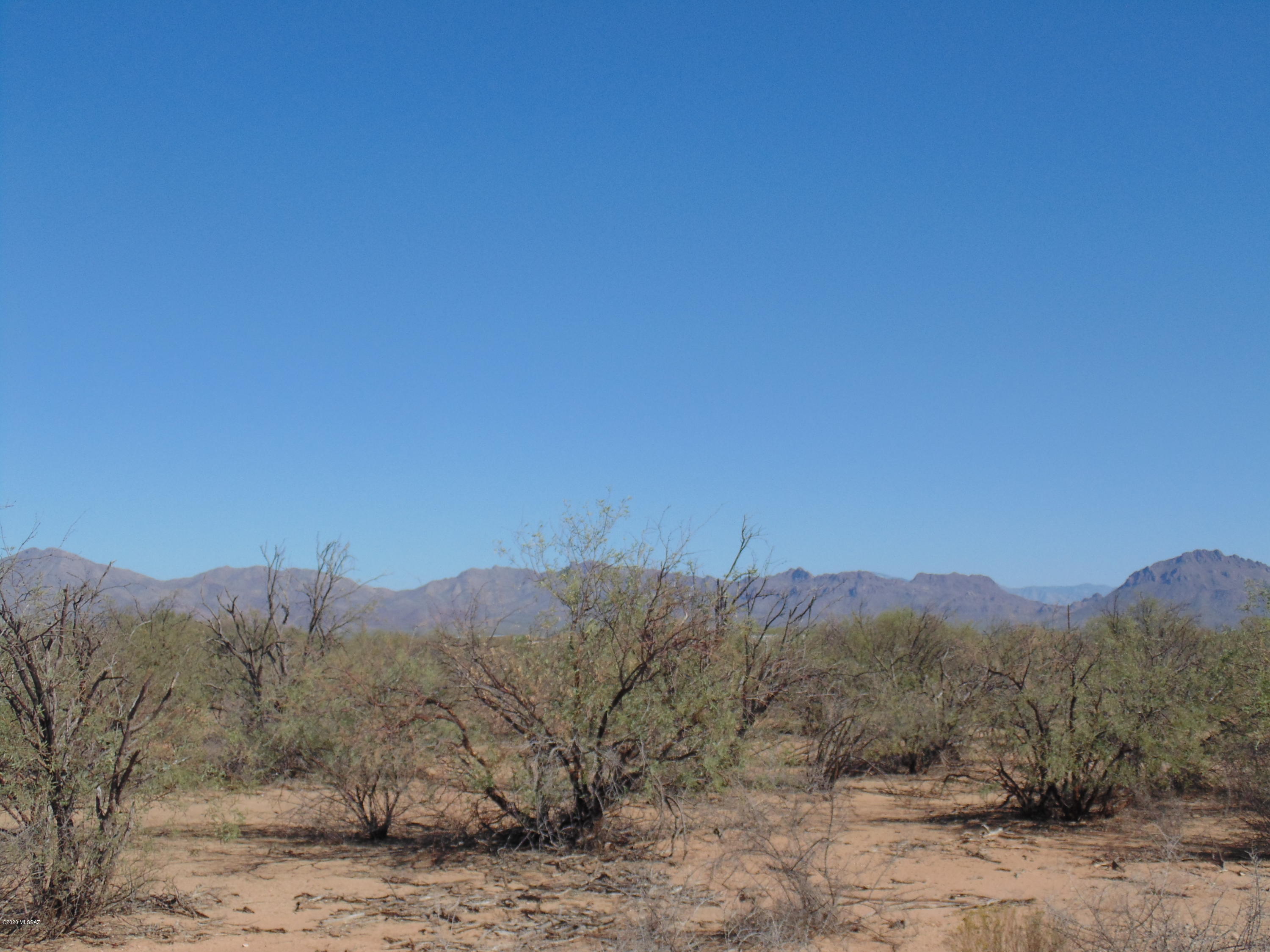 Flat 4.36 acre parcel perfect for your next home.  Electric and well at lot line.  3 sides fenced by surrounding properties.  Great mountain/sunset views