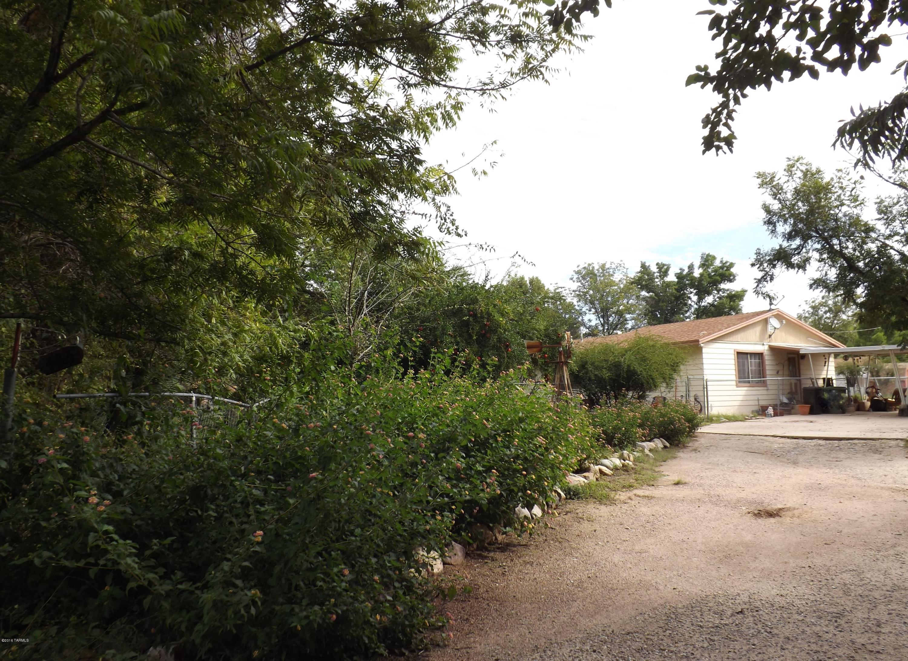St.David Ranch tucked away in the trees!4 bedroom 2 full bath with large living room kitchen and dining. Generous sized bedrooms. Beautiful fenced grassy front yard with huge trees for a private oasis. Storage sheds in the back with space for animals or RV parking. Covered Carport. newly installed central AC/heat unit. dual pane windows throughout.Hurry to see this home today!