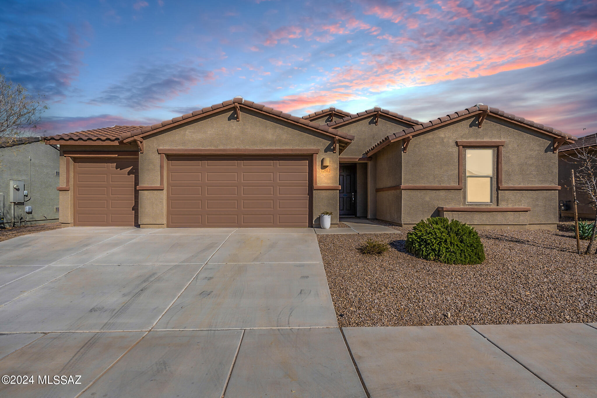 Why consider new construction when this ''quick move-in'' with all the finishing touches & upgrades is waiting for you? Welcome to your entertainers' paradise in Marana's desirable Gladden Farms. Situated in Heritage, enjoy mountain views, awe inspiring sunsets & easy access to walking & bike paths. Your energy-efficient home is tastefully enhanced with custom design elements & additional desired features. A 4-car garage with pull-through, charming board & batten wall accents, built-in cabinetry off the owner's entry, a stack stone wall in the great room, are just a few. Richly appointed spaces with wood-like tile floors & wide hallways lead to a light & airy den which could convert to a formal dining space or 4th bedroom. Your open kitchen boasts ample counter & cabinet space, & a large quartz-top island. The primary bedroom is off the dining area & offers an added sliding glass door, providing access to the sparkling backyard pool. The primary bathroom features dual vanities, a walk-in shower & a generous walk-in closet. Find your refuge or host epic outdoor gatherings in your sun-dappled backyard. Your sparkling, self-cleaning "pebble fina" pool with travertine surround is awaiting pool parties or swimming under the string lights at night. The master-planned community features a splash pad, baseball & soccer fields, two dog parks, a trail system, bike paths, community garden, multiple parks & more! Association hosts community events year-round. Why wait for new, when this is ready for you! Sellers did all the work! Don't miss this turn-key home! Schedule a private tour today!