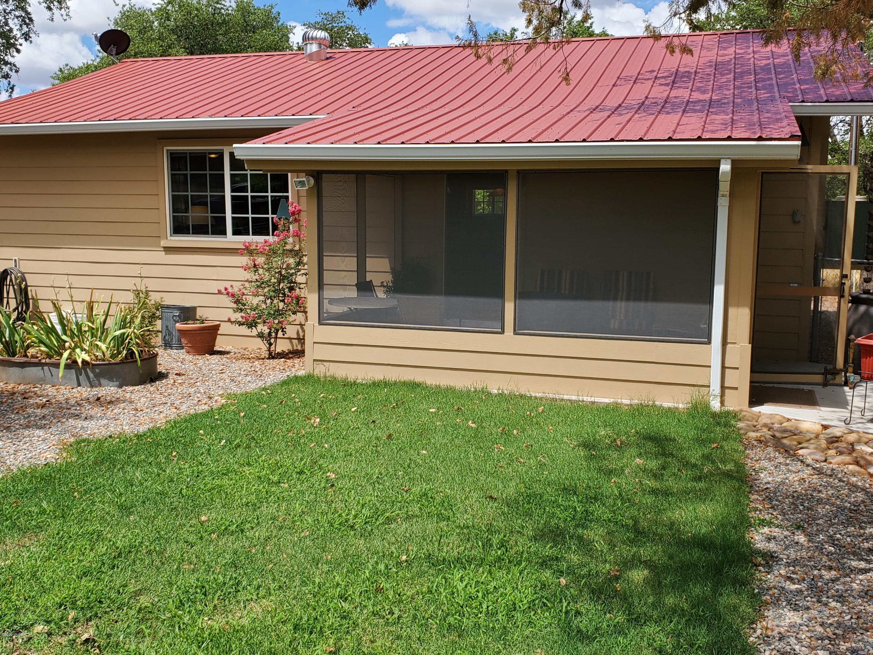 Unique renovated 2BR/1BA country home with PRODUCING VINEYARD snuggled high on the slope of the Chiricahua Mountain foothills amongst oaks, sycamores, ash, and cottonwood trees where wildlife abounds. 20 acres total - surveyed into five 4-acre parcels on ROCK CREEK with stunning views and seasonal creek flow in Arizona's premium vineyard area. 2 fenced acres are planted with Syrah and Fiano grapes with 8 addn'l acres cleared to plant.  Large 44x24 insulated METAL SHOP/GARAGE with dedicated 220 amp outlet, cement floor, (2) 3000 gallon water storage tanks.  PRIVATE WELL. Home was renovated in 2012 with new metal roof, plumbing, electrical, hardy board siding, screened porch, mud room and propane gas line. List of furniture and equipment included in the sale will be provided to prospective buyers