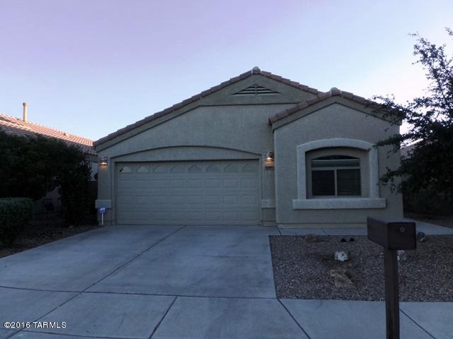Pristine, SOLAR POWERED for huge electric bill savings,  move-in ready, Lennar built home in the desirable Mesquite Ranch neighborhood in the coveted Vail School district, in a very nice cul-de-sac. This 3 bd/2 ba great-room design floor plan boasts lots of counter and cabinet space in kitchen with all appliances, tasteful wood laminate flooring throughout with tile in all wet areas, surround sound speaker prewired, alarm system installed, master bedroom with his/hers closets, garden tub and dual vanities. Enjoy serene nights in a spacious rear yard with covered patio and no rear neighbors to spoil your mountain views! The neighborhood has 2 community pools, walking/running trails, playgrounds and basketball court! priced right and ready to sell!  Come and get it!!