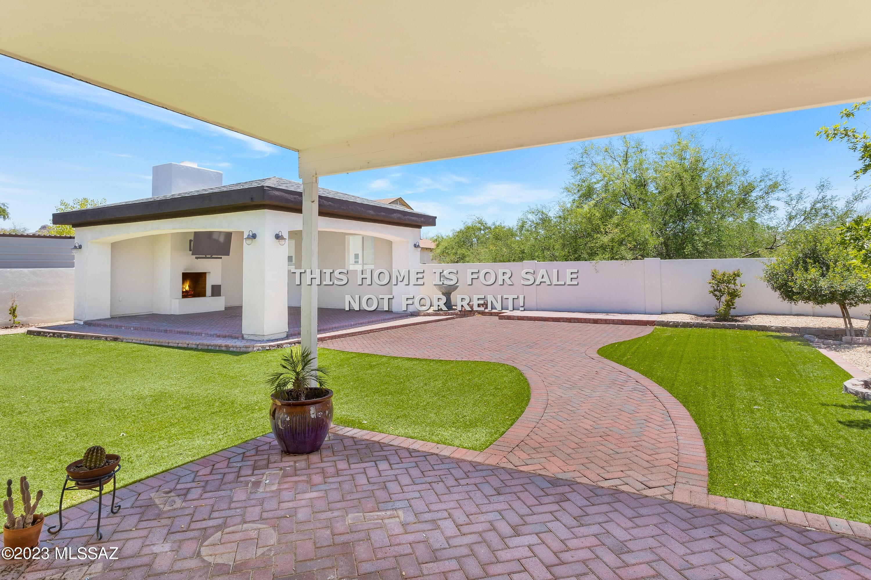 ENTERTAINER'S DREAM! You'll LOVE this spacious 4 bedroom, 2 bath, home with two-tone paint, two-panel doors, modern faucets & fixtures. This well-maintained home is situated on a large lot with no homes behind & a $68,000 professionally landscaped back yard with Pavestone patio & sidewalks, brick borders & planters, low care artificial turf and a massive 25' x 20' pavilion with fireplace, big screen TV, and open beam ceiling which has hosted two weddings! The kitchen has an abundance of 4' hickory cabinets, stainless steel appliances & granite countertops. The 16 SEER, energy efficient AC is two years old & with travertine & ceramic plank tile will keep you COOL on even the hottest days! Why settle for LESS when you can have it ALL? Owner financing available at 5.50% with 20% down. HURRY!