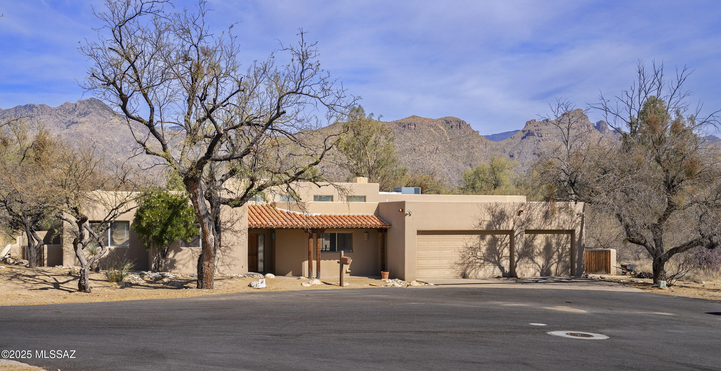 Located in pristine Hidden Valley, close to Sabino canyon, this beautiful and  private 4BR/3BA home featuring a split bedroom plan is situated at the end of a culdesac. Open floor plan with a stunning great room with high ceilings and fireplace. Spacious dining area has built in cabinetry with bar, sink and wine fridge. Great Room opens to kitchen which is at the center of the home with eat at island counter with second sink, a walk in pantry and lots of cabinet space.Beautiful backyard w panoramic mountain views is perfect for entertaining, begins with screened outdoor patio that opens to magnificent pool and spa. Lovely Primary Suite has a separate sitting area, large enough to use as a study or library. Primary bath features double vanity and separate tub and shower. The 3 guest rooms