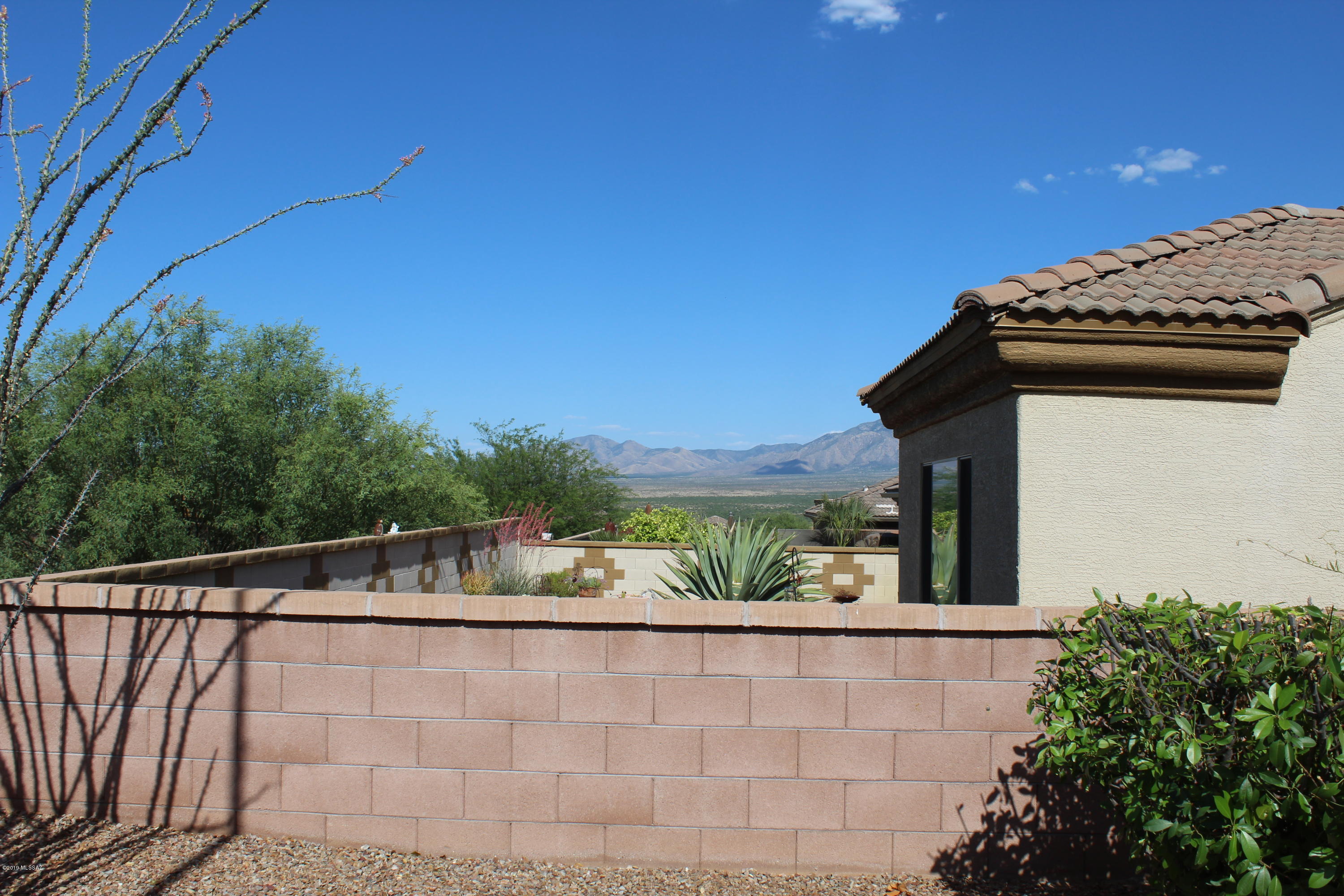 Gorgeous view of the Mountains!  Three car garage Dragoon floor plan w/freshly painted exterior is priced to move quickly.   You will love the floor plan as it was a favorite built by Meritage.  In the great room is a gas Kiva FP painted in a pop of color. Wide open floor plan makes it ideal for entertaining.  Highly upgraded kitchen has Cherry cabs, granite C-tops, island & butler pantry.  Sweeping arches define spaces while allowing them to flow seamlessly.   There is a screened in AZ room and a hot tub in back.  Backs to large common area with a sweeping mountain view...make it YOURS today!