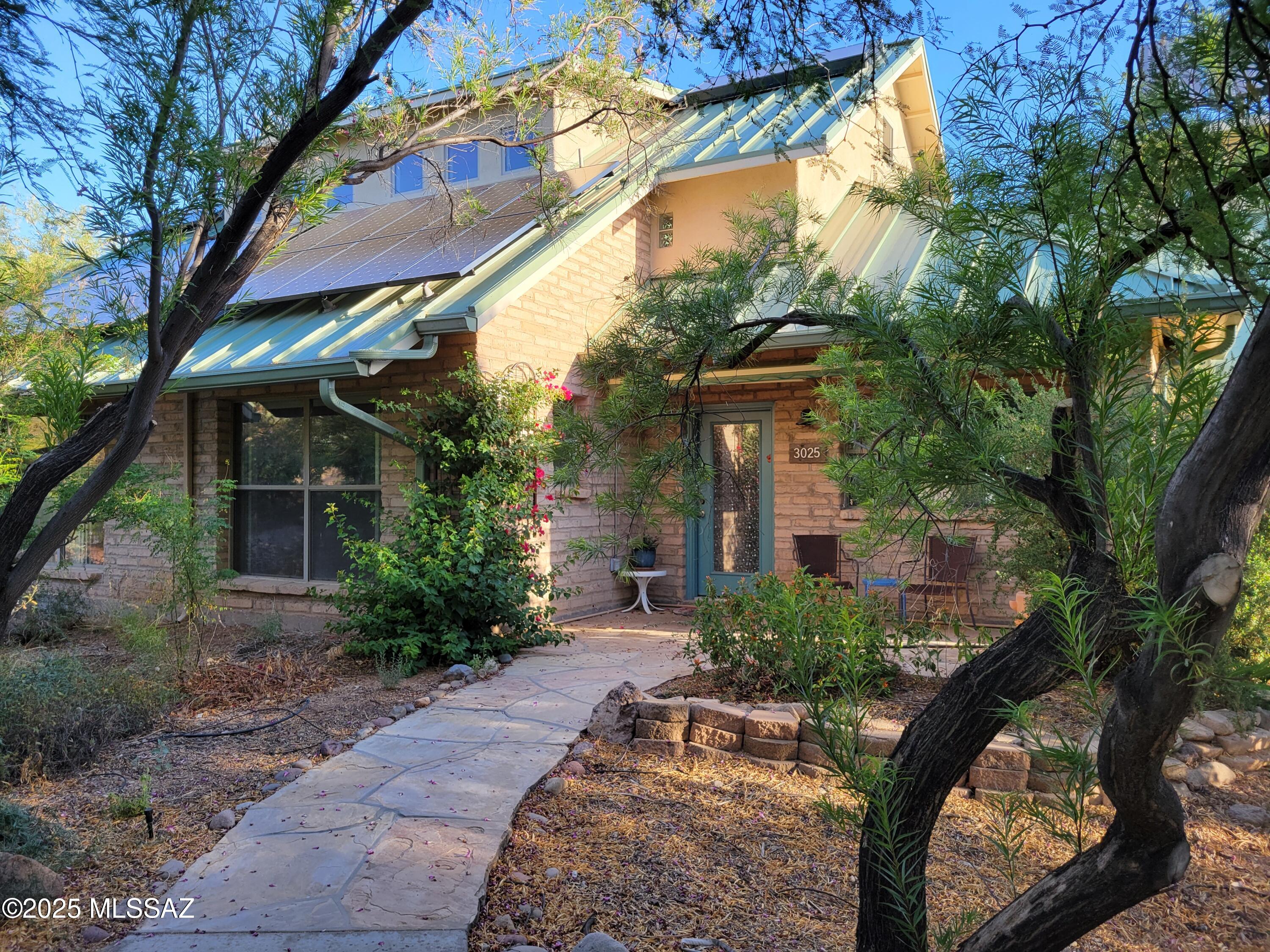 Welcome home to the peaceful, intentional community of Milagro Cohousing.  On the internet, visit MilagroCohousing.org to view the purpose and design of this 8-acre community, consisting of 28 homes and a common house, swimming pool, workshop, and EV charging stations, surrounded by native desert open space on the 43-acre site. Relax and renew yourself in this caring, quiet, safe space.
Custom cherry cabinets in the kitchen, golden granite countertops with built-in breakfast bar and wine rack.  Owned solar and 400 amp service panel. 
The construction is well engineered and durable with metal roofs and thick adobe walls.  The floors are wood grained ceramic tile on the ground floor and pine planks upstairs.  The panoramic views to the north are forever.