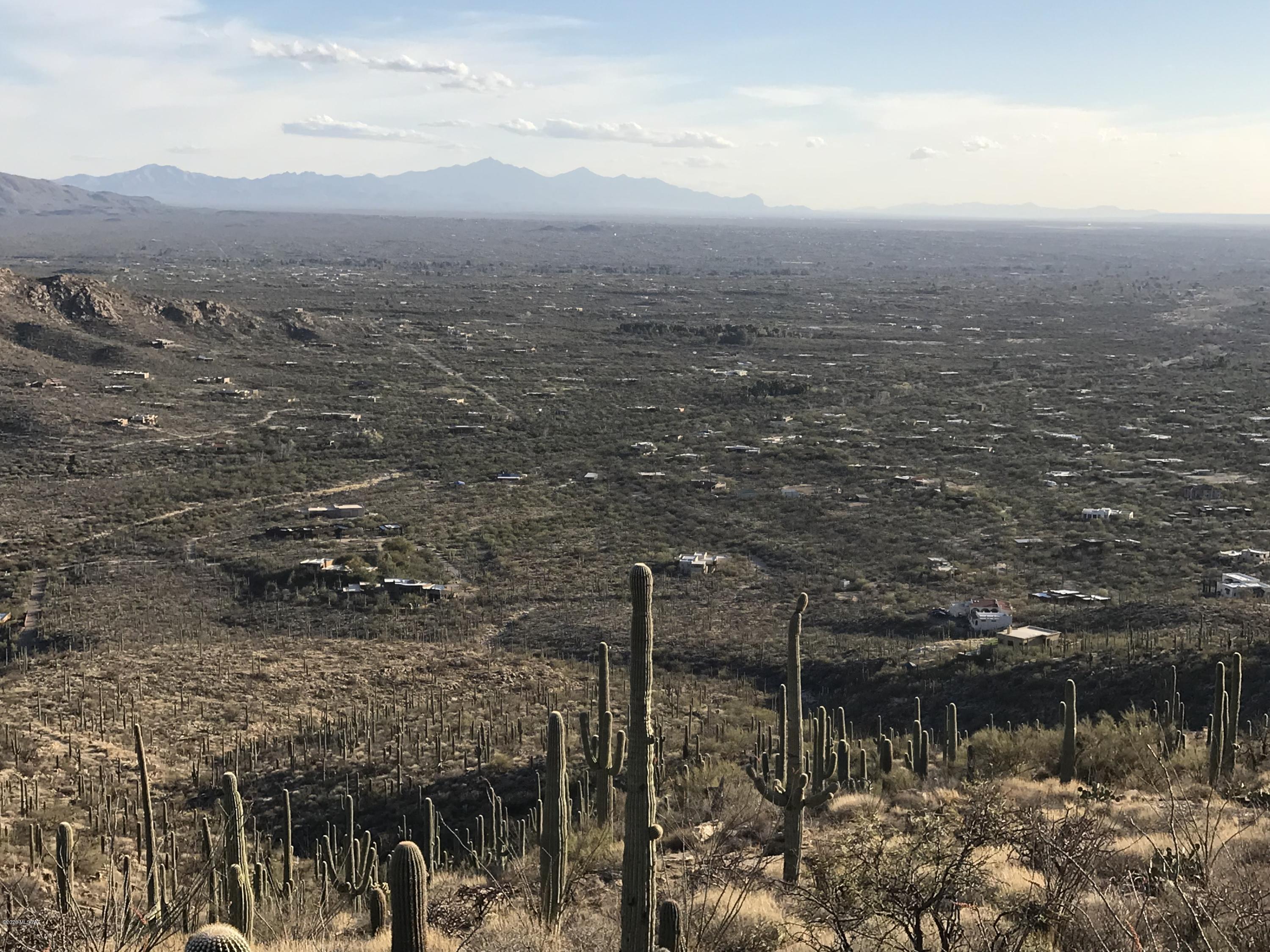 Unique elevated acreage that overlooks all of Tucson & Mexico. Rolling hills set this amazing backdrop for a buyer to build a  custom stick built house with accessible electric and cable on the property.  Gated community close to Agua Caliente Park and in the heart of the Prestigious Tanque Verde Valley. Come and enjoy this one of a kind piece of land.