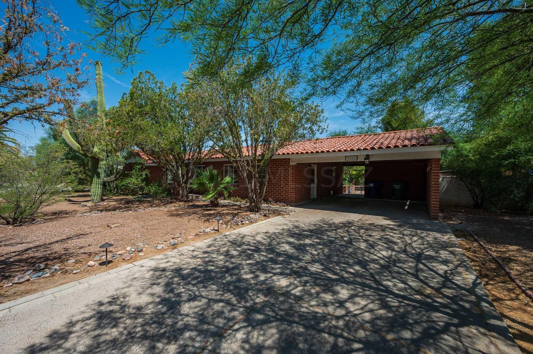 Come see this beautiful central charmer ranch style home located in the historic San Clemente neighborhood. Property taxes are lower due to historic neighborhood designation, big benefit! This ranch style home features a bigger central Tucson .30 acre lot w/mature tree growth in backyard. The classic Spanish tile roof gives the home a unique charm. Inside the home it features a split floor plan w/ 3 bedrooms and 2 full baths. Large living area with a beautiful fireplace & large windows looking into the lush backyard. Don't miss out on this central charmer with the space to enjoy the outdoors!