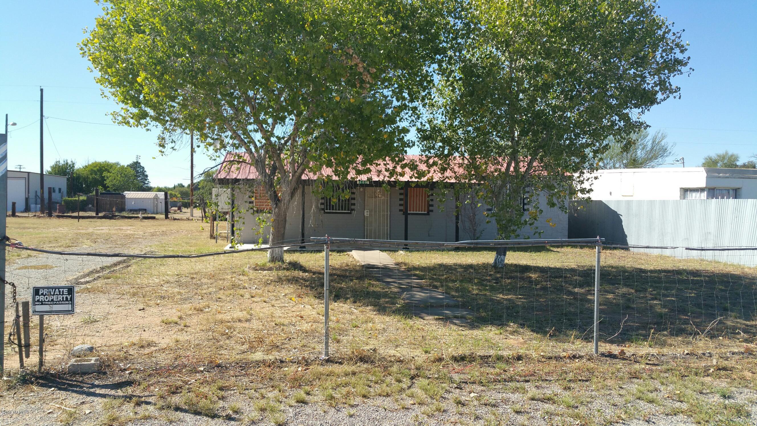 This unique 3bd 1bath house sits on lg fenced lot big enough for a yard, play area, garden, even a pool. This property is ideal for a creative, motivated, diy'er or professional carpenter. The bdrooms are small but bright with 2 windows each. Off the kitchen is lg pantry/storage area and there is a lg laundry room big enough for sewing table and linen storage. The interior is painted in deep vibrant colors throughout - take the previous owners lead or whitewash it and start from scratch. The windows are adorned with rod iron bars for appearance and protection, but mounted from the outside they do not open to allow escape from the interior. There are no appliances, window coverings, heating or cooling equip. Property is sold as is and Seller makes no property, well or septic disclosures.