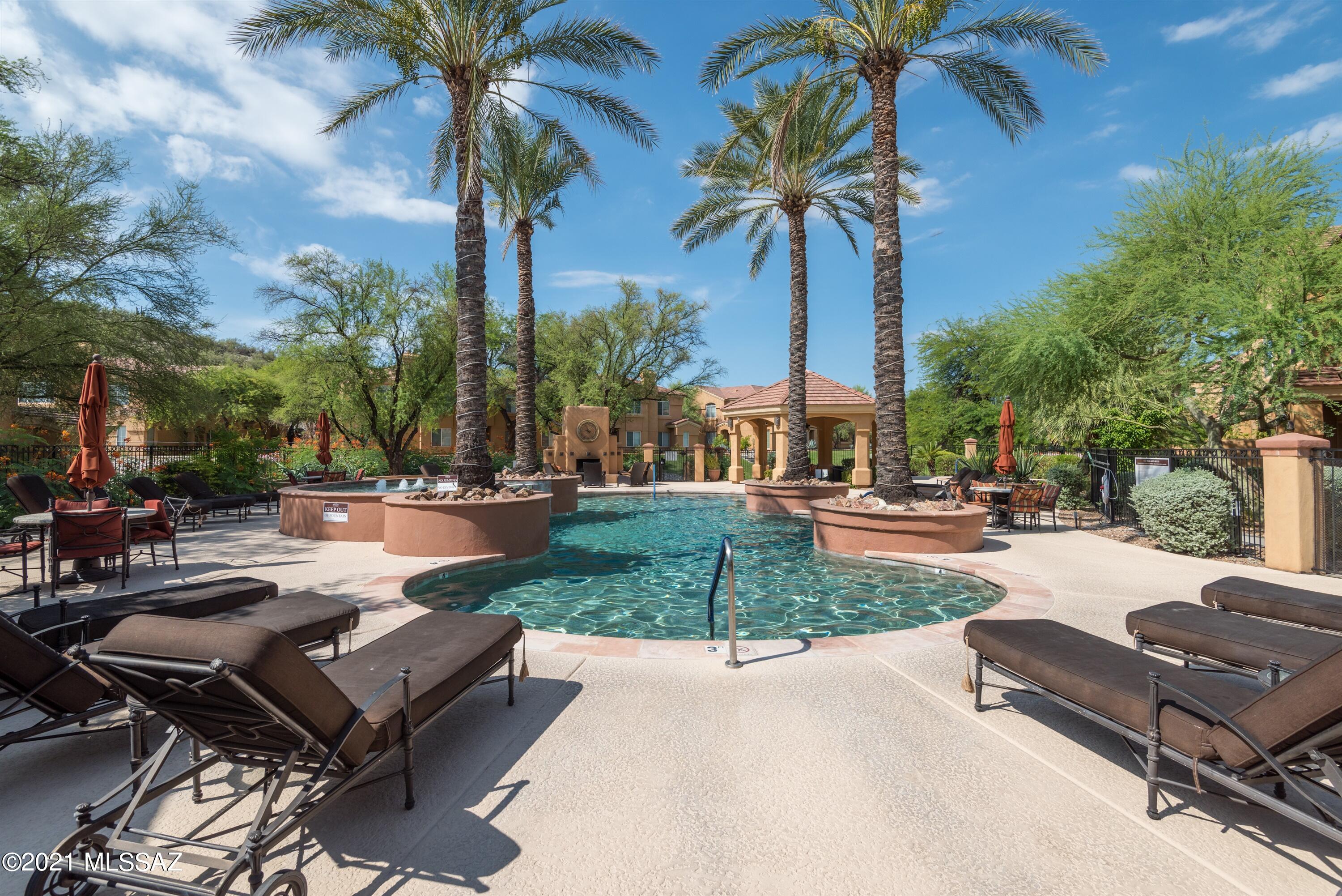 Spacious remodeled corner unit 2nd floor condo in the popular gated community of Pinnacle Canyon Condos. A 3BR condo has not been available for sale in this community since 2019.  This charming Catalina Foothills property features an open floor plan with an abundance of natural light, eat-in kitchen with granite counters, split bedroom layout, laundry room (not a closet) with washer / dryer included, romantic wood burning fireplace, roomy master suite with walk-in closet, interior staircase, mountain views and a convenient Northern Tucson location across the street from shopping & numerous restaurants and close proximity to Sabino Canyon Park.  The Pinnacle Canyon resort style amenities include a heated pool & spa, clubhouse with gym, bbq grills and award winning grassy park-like grounds.