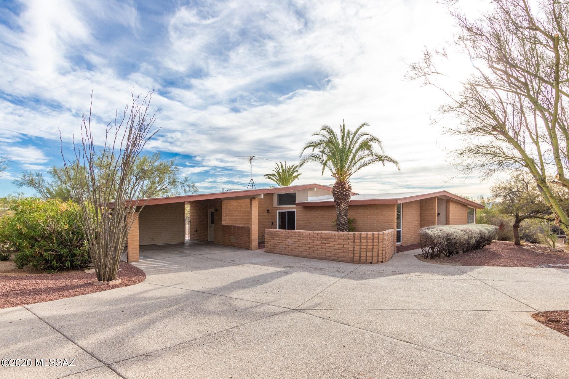 Sought after Casa Adobes Neighborhood; Just under an acre of land!. This home with Pool has been completely updated. Step inside this 4 bdrm 2 bth modern home. Kitchen with lots of cabinetry and granite countertops, stainless steel appliances and a wood burning fireplace . Great room with dining and soothing color tones to complete this home . Generously sized bedrooms, a master en-suite, walk in shower with ceiling height tile  Enjoy time soaking in the pool in this spacious back yard w/dog run included   Come make this your home.