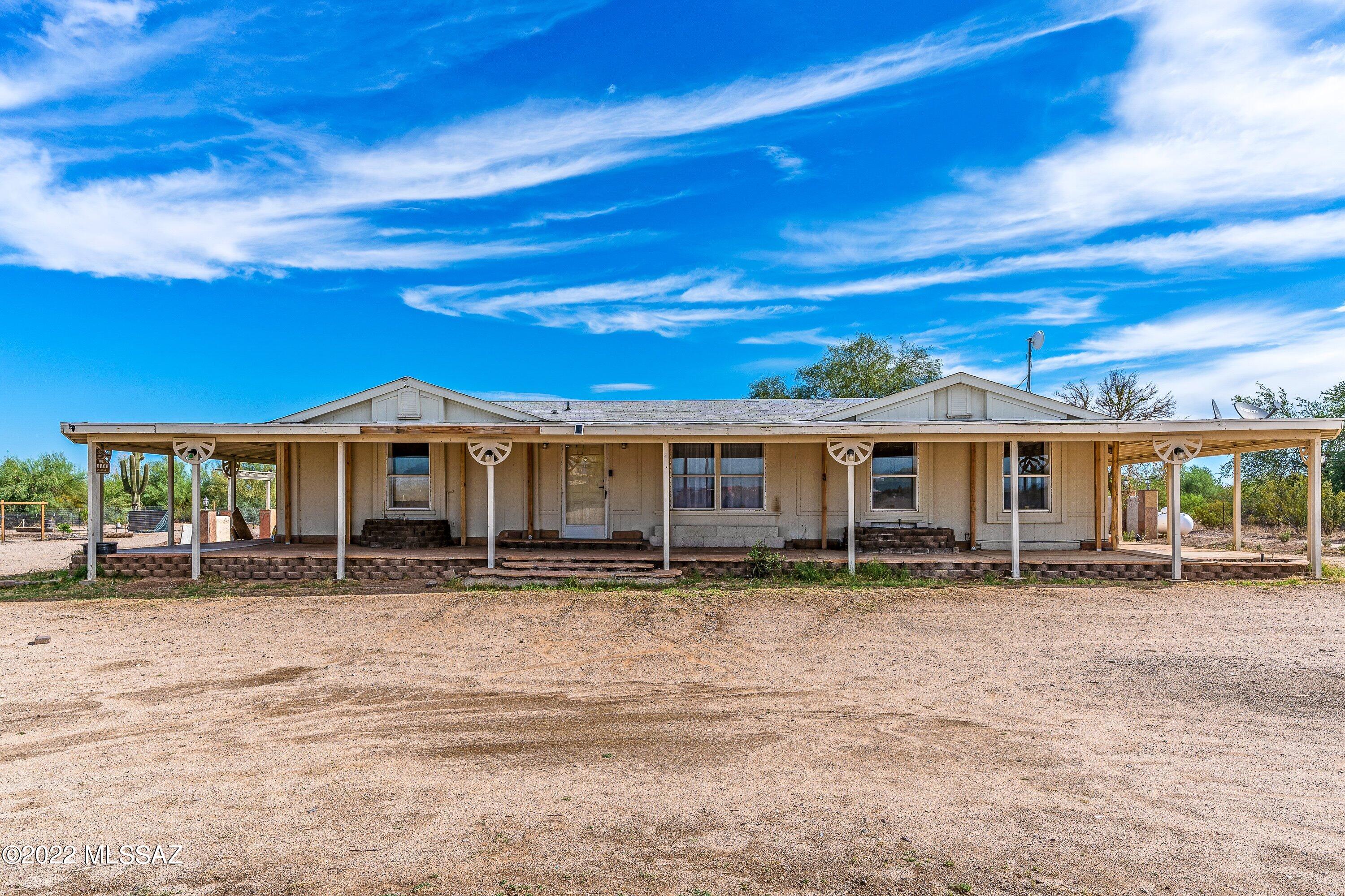 Beautiful, ground-set, triple-wide manufactured home with 4+ acres on horse property.  Flagstone decking and wood porch/awning all around the home!  The home has a gazebo with an enclosed backyard with a stucco wall, flagstone pillars and a greenhouse.  The house is great, but you'll fall in love with the land and peace and quiet of country living!