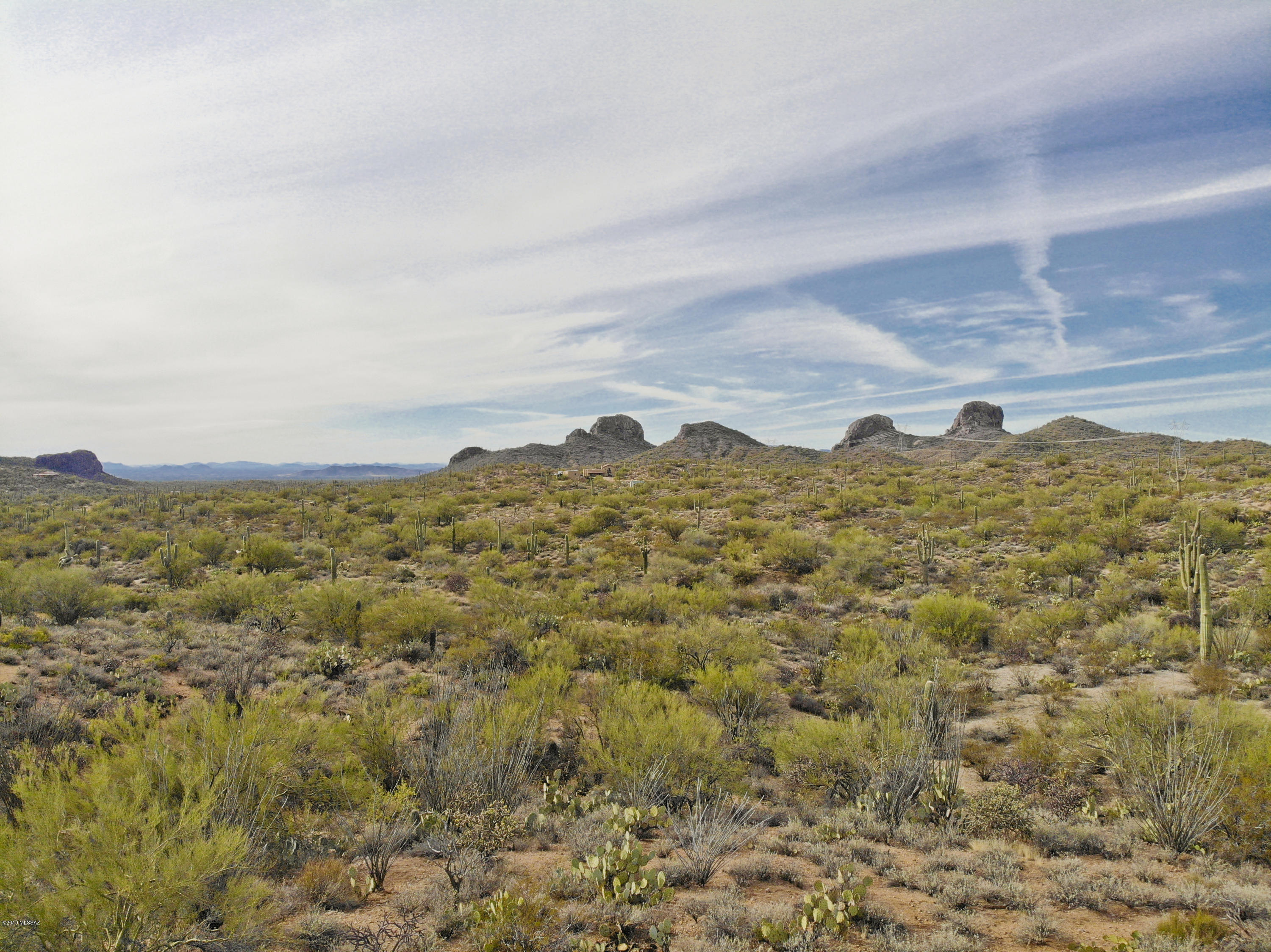 This stunning 10 acre lot is exquisitely sited between the Tortolita Mountain & Owl Head Butte, removed from the excessive traffic & noise of Tucson. The property offers a relaxed lifestyle and can be set up with solar & water harvesting application to be ''off the grid.'' Enjoy the natural beauty of the Sonoran desert in all of its splendor with a wide variety of cactus & native plants. Build your home on-site and enjoy the peace of quiet of rural living, but with convenient access to I-10 & SR-79. Don't miss your chance to experience this exceptional property. Buyer to verify all information.