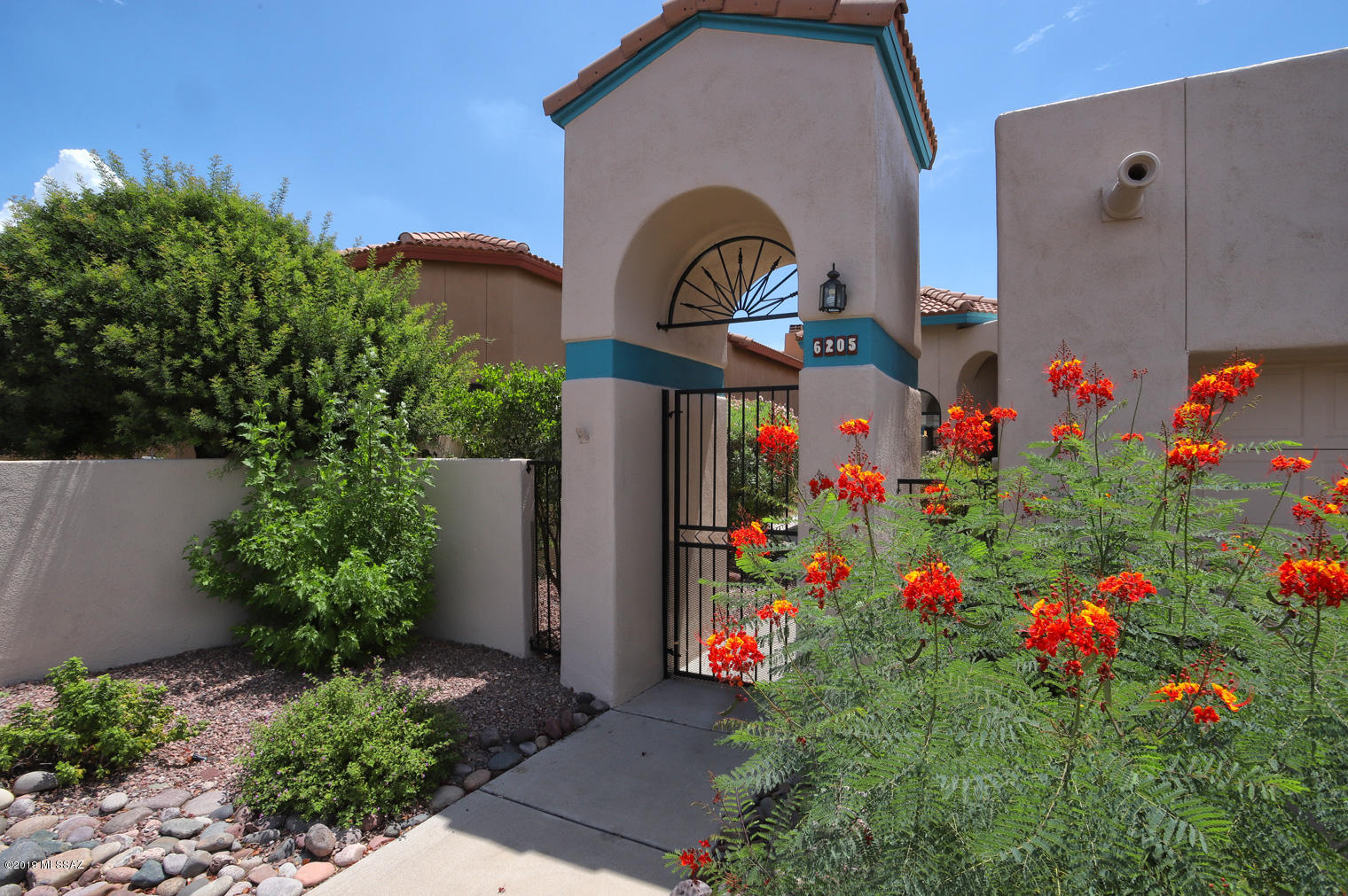 Beautifully updated townhome in gated Kachina Hills. Very convenient central Foothills location is just minutes from a wide selection of fine restaurants, services and shopping. This special home is move-in ready and features gorgeous porcelain tile throughout, a spacious kitchen with all new appliances and a bay window with great mountain views. Wonderful master suite includes a slider to the patio, walk in closet and separate tub and shower. The large covered east facing patio backs to a natural area and includes brick pavers and mountain views. Generous spaces, yet an easy house to lock & go. Sparkling neighborhood pool and spa are just steps away. House was re-plumbed with the PB Pipes replaced in 2014.