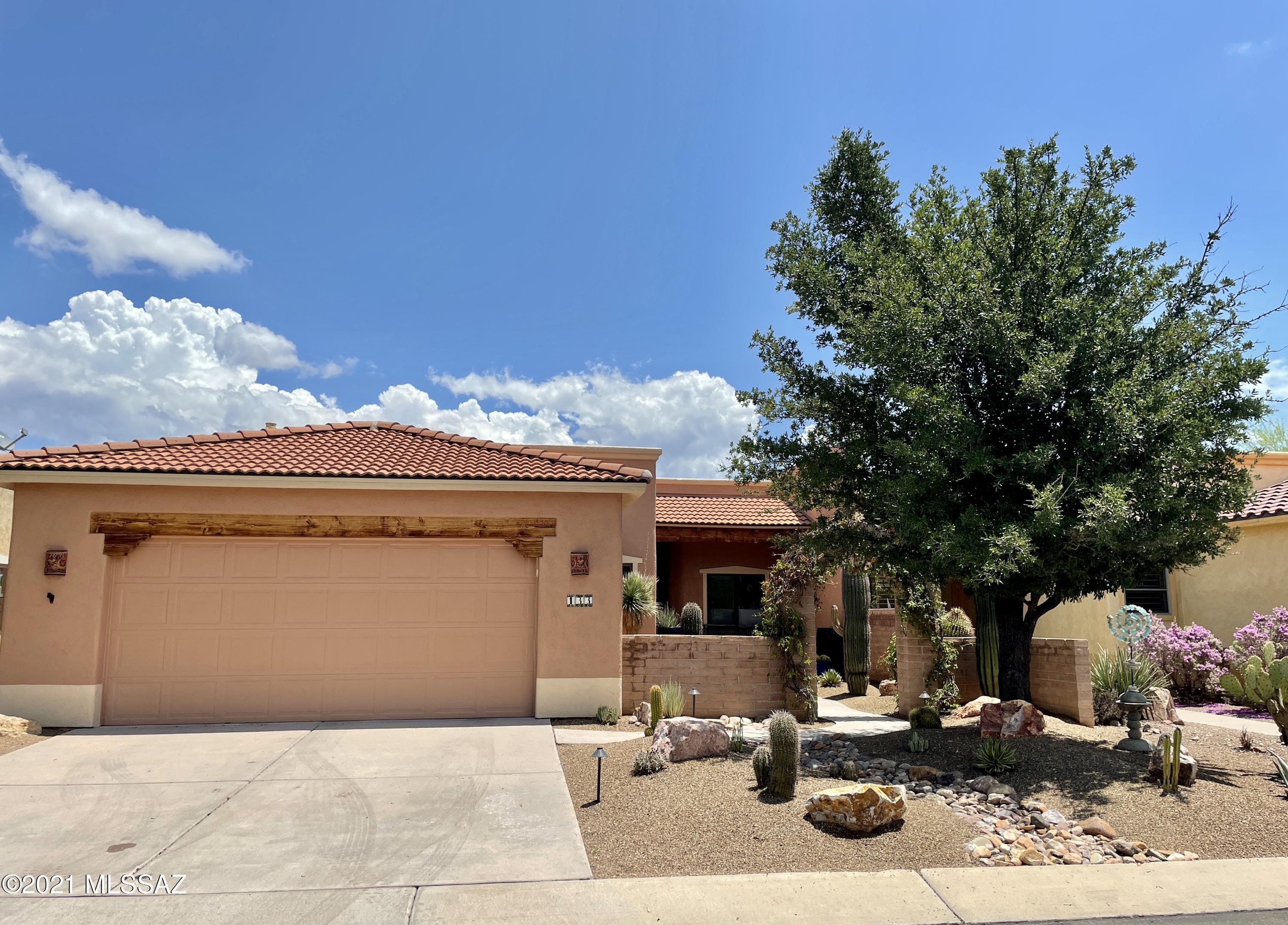 This spacious, 2 bedroom, 2 bath home in the desirable Bosque neighborhood, features an open plan that is filled with natural light. Enjoy a cup of coffee in the morning, and glass of wine in the evening on the huge covered porch with views of the Santa Rita Mountains. There is a separate office/studio, and a very large utility/laundry room. Double garage with large driveway for overflow parking.