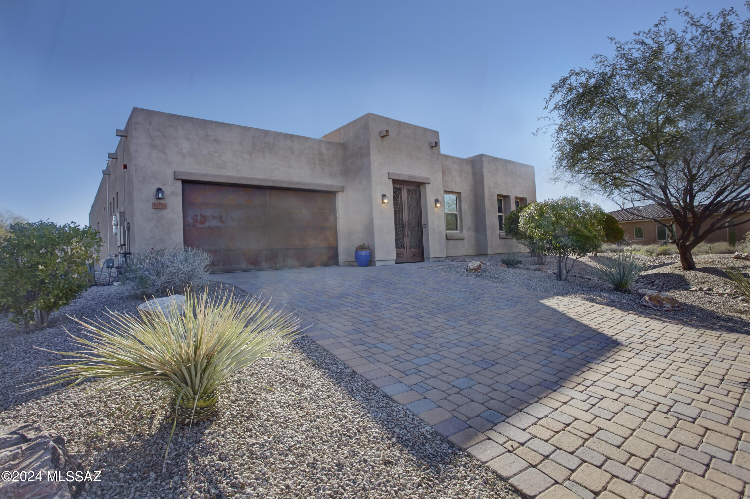 Inside the small, gated community Rancho Del Cobre in Oro Valley, a turn-key home awaits at 11726 N Luzon Court. This enclave was thoughtfully designed with larger lots for more space & privacy, while maintaining a neighborhood feeling. Built in 2016, with a variety of recent enhancements and an owned solar system, this lovely residence is ready to enjoy. A gated courtyard entry, with fresh epoxy, leads way to a custom front door. Inside, a spacious 2,977 sq ft floor plan includes 4 bedrooms, 3 full bathrooms, along with 2 flexible spaces to accommodate modern living. The chef's kitchen includes granite counters, a gas cooktop with a professional hood, double ovens, a reverse osmosis filtration system and walk in pantry. Several spaces have been freshly painted and new Karastan carpet has been installed in all the bedrooms. Ample storage is available in the 3-car tandem garage, which also includes a state-of-the-art water softener.

The Eastern facing backyard has been completed to perfection. A custom designed, heated & cooled, saltwater swimming pool surrounded with travertine decking features a pebble tech finish, a water feature and fire feature. Purchased in 2023 and offering all the bells and whistles, the freestanding hot tub conveys with the home.

Convenience from this location is plentiful. Across the street, sits a neighborhood park with space with ramadas and a large grassy area. Wilson K-8 School is walkable, and Ironwood Ridge High School 1.4 miles away. Immediately to the south is access to a paved multi-use path that connects to "The Loop." Within 3 miles, you will find the Oro Valley library, Naranja Park, and multiple plazas with grocery, dining, pharmacies, and other services. This location boasts all the benefits of living in Oro Valley, while offering immediate access to La Cholla Blvd, making commuting or traveling Downtown quicker.