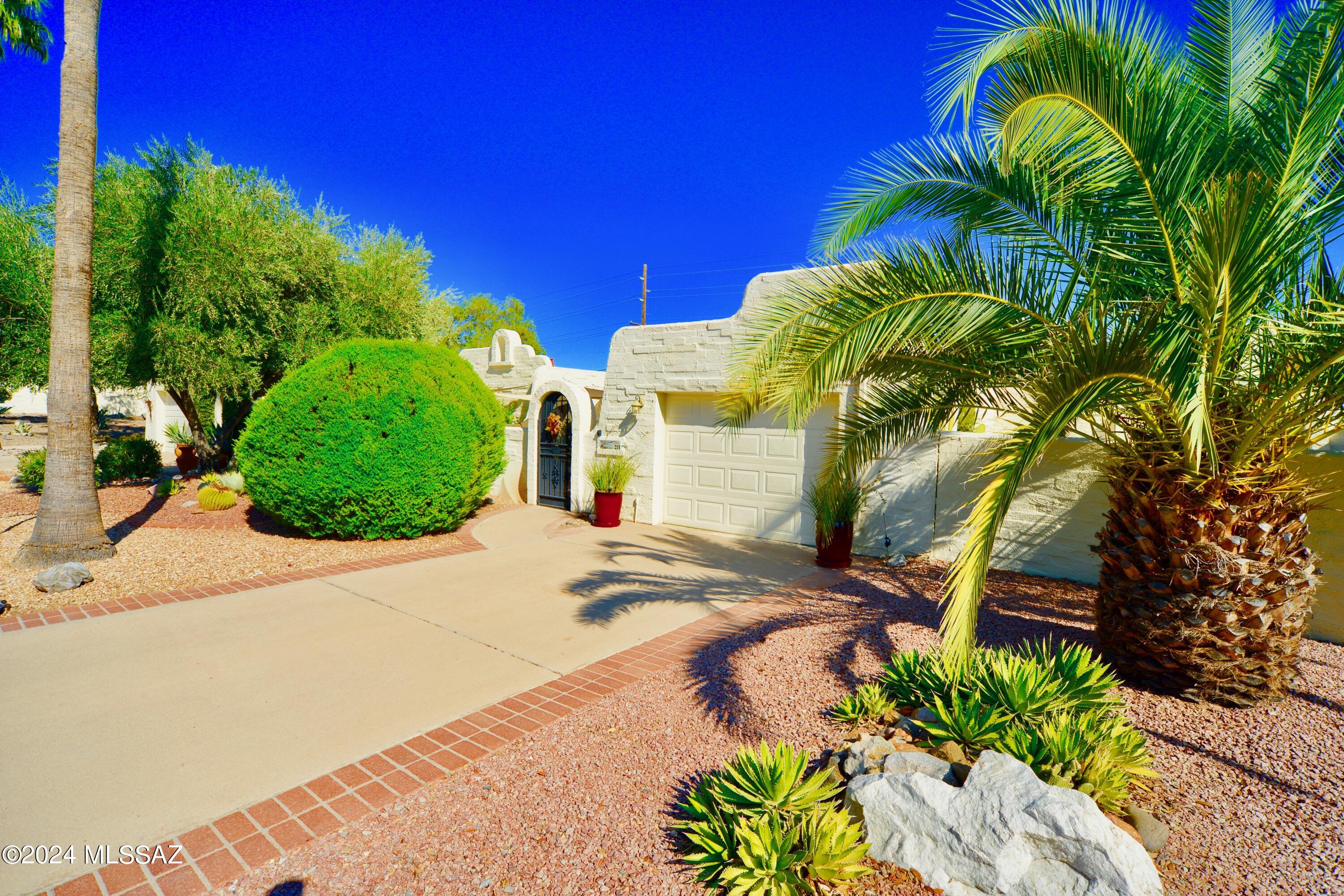 Sophisticated & charming 1,479 sq ft 2-bed townhome in highly sought-after Esperanza Estates has everything you desire. Character, privacy, desert & peek boo views +large living space w/ just enough artistic flair. From the moment you step through the wrought iron gate, the lush front courtyard oasis, complete w/ mature plants and shade, evokes a feeling of French countryside meeting coastal Spain. Inside, the light & bright enclosed entryway offers the perfect spot for an artist studio or home office. The generous living area, flowing seamlessly into the expanded bonus room, offers a delightful sunny spot for entertaining, hobbies or just extra space for comfort & relaxation. Thoughtfully designed, this home offers abundant outdoor seating areas, graceful living spaces & a prime location