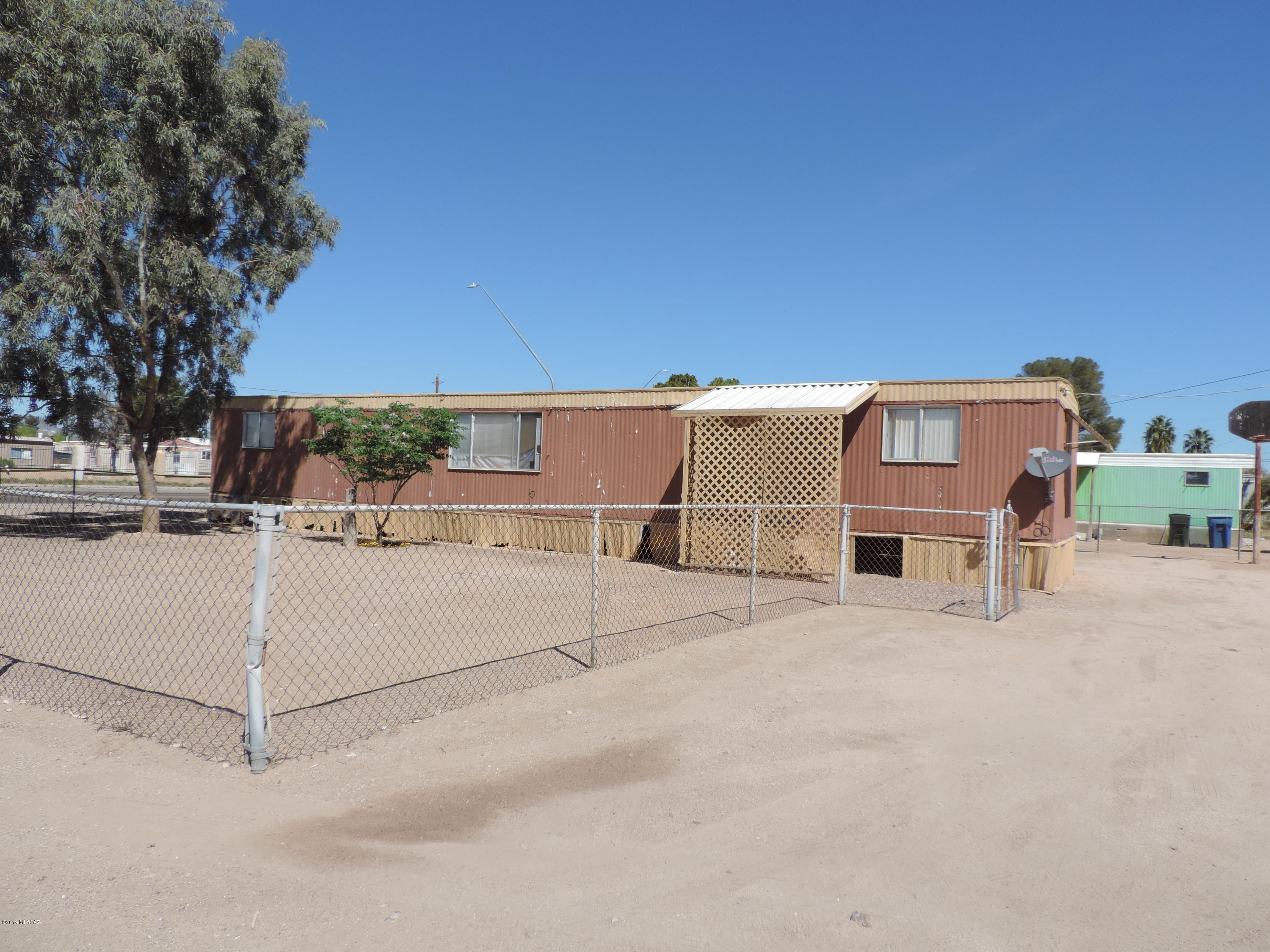 Looking for an investment or low cost living?  Here is your opportunity to own this these two lots totaling 14375-sf, with two mobile homes with each having 3 bedrooms. Live in one and rent out the second home.  The lots can be split per the planning department then you could sell the units separately. Zoning is Tucson-MH1, which the zoning department states you can put a new mobile, build A duplex or a single family home. Sale includes both lots 13 and 14.  Homes and properties are being sold ''AS IS''.