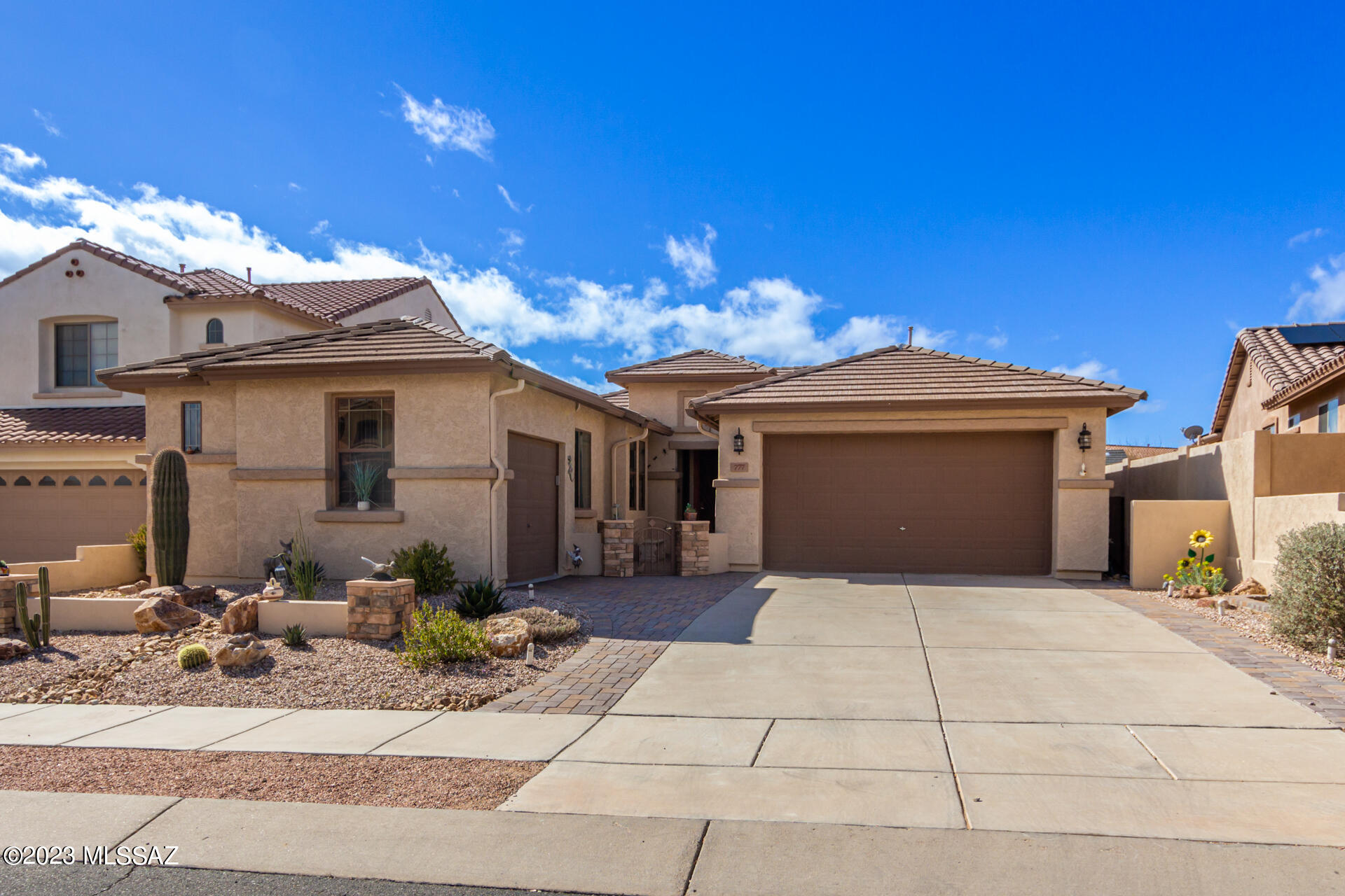 Range price $400,000-$425,000. This gorgeous home in gated Rancho Sahuarita is calling your name!  The custom courtyard & extended floorpan with 3 car garage are just the beginning. Tile & wood-look flooring are throughout the home. Open living room w/ custom stone fireplace is perfect for entertaining! You'll love the gourmet kitchen boasting SS appliances, granite counters, loads of cabinets, tile backsplash & pendant lighting, plus a huge island breakfast bar. Large main bedroom has an ensuite with dual sinks & a walk-in closet. Relax and enjoy the beautiful landscaped backyard with an enclosed patio, pergola, natural grass, and pavers in all the right places! From lakes, parks and walking trails to a waterpark the amenities offered in Rancho Sahuarita are second to none!