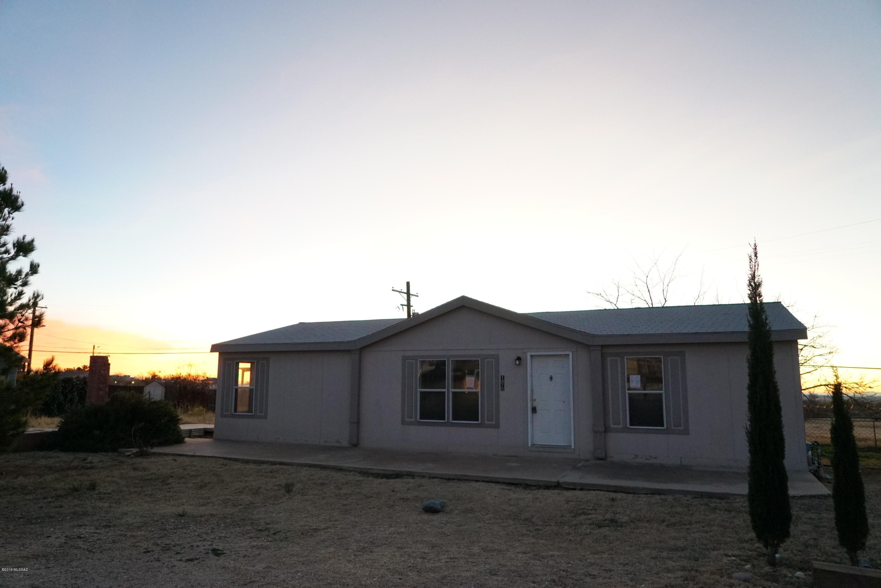 Don't delay! This one will go quick! New flooring and paint! White stove and vent hood will be installed during escrow. Enter Large Living room with split bedroom plan with master on South side of home and 2 bedrooms on North side. Huge Kitchen with dining area in it and center island and dual sinks. Laundry is off the kitchen. Back patio is covered with a beautiful grown tree in the fenced backyard. Back yard has fabulous sunset views. Close to oracle Rd. and shopping. There used to be a large garage on the property with remnants ready to rebuild. Concrete Pad is poured and 4 columns are there waiting for walls and a roof. Make this fabulous home yours today!