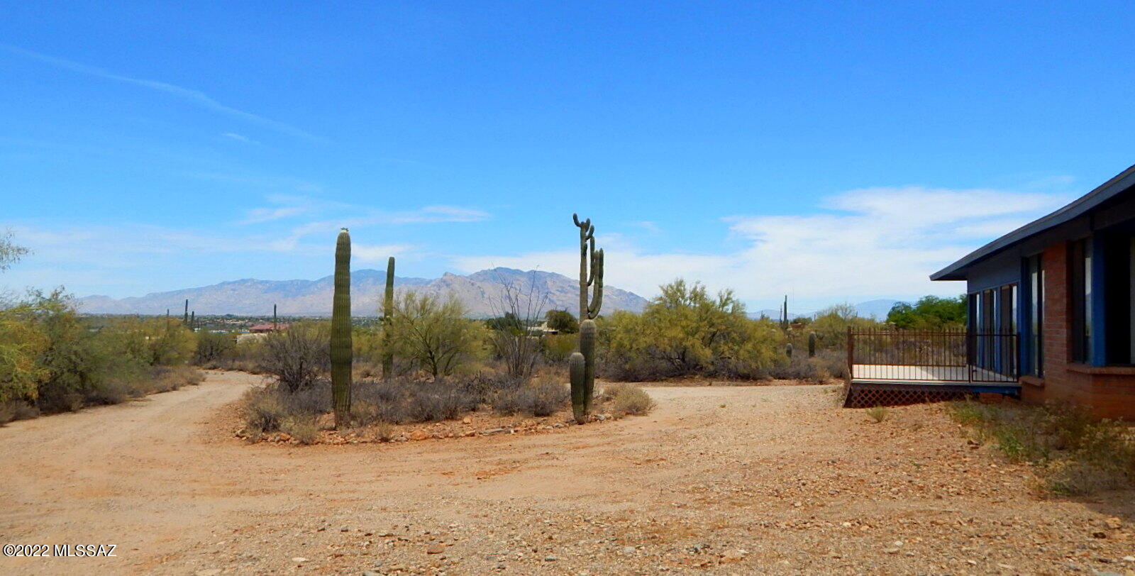 Buy NOW and save $$$$. This property will be freshened up & a large price increase after clearing out at the estate sale. Hoarder situation from previous owner. Custom built home w/ a 750sq ft, 1 BD guest house on 3.3 elevated acres. Off Ina, west of Silverbell.  A real desert house w/ floor to ceiling windows. Mid-Century influence to marry the indoors w/ the outdoors. Exposed adobe block interior walls w/ exposed beams above the walls. 3 BD. Large kitchen w/ lots of cabinets & huge island. Breakfast area. Large 2-sided fireplace. Easily could be 2 master baths. Now has 2 toilets, 2 large closets, 2 sinks, 1 walk in shower and 1 soaking tub. Powder room. The north patio was converted to a room for an art studio for extra sq ft. Heated & cooled space approx. 2700 sq ft +-. Private well. . Horse property. House & guest house are under 1 roof, connected by a breezeway. Cosmetic fix up.  My interpretation: money was spent when needed to keep it above average. The roof looks very good. Both HAVCs serviced. Termite inspection done. Location is superb. Driving approach to the "front" courtyard and front door needs some better curb appeal. Stunning mountain views from the back deck. Huge upside to this property. Under carpet might be colored concrete.
