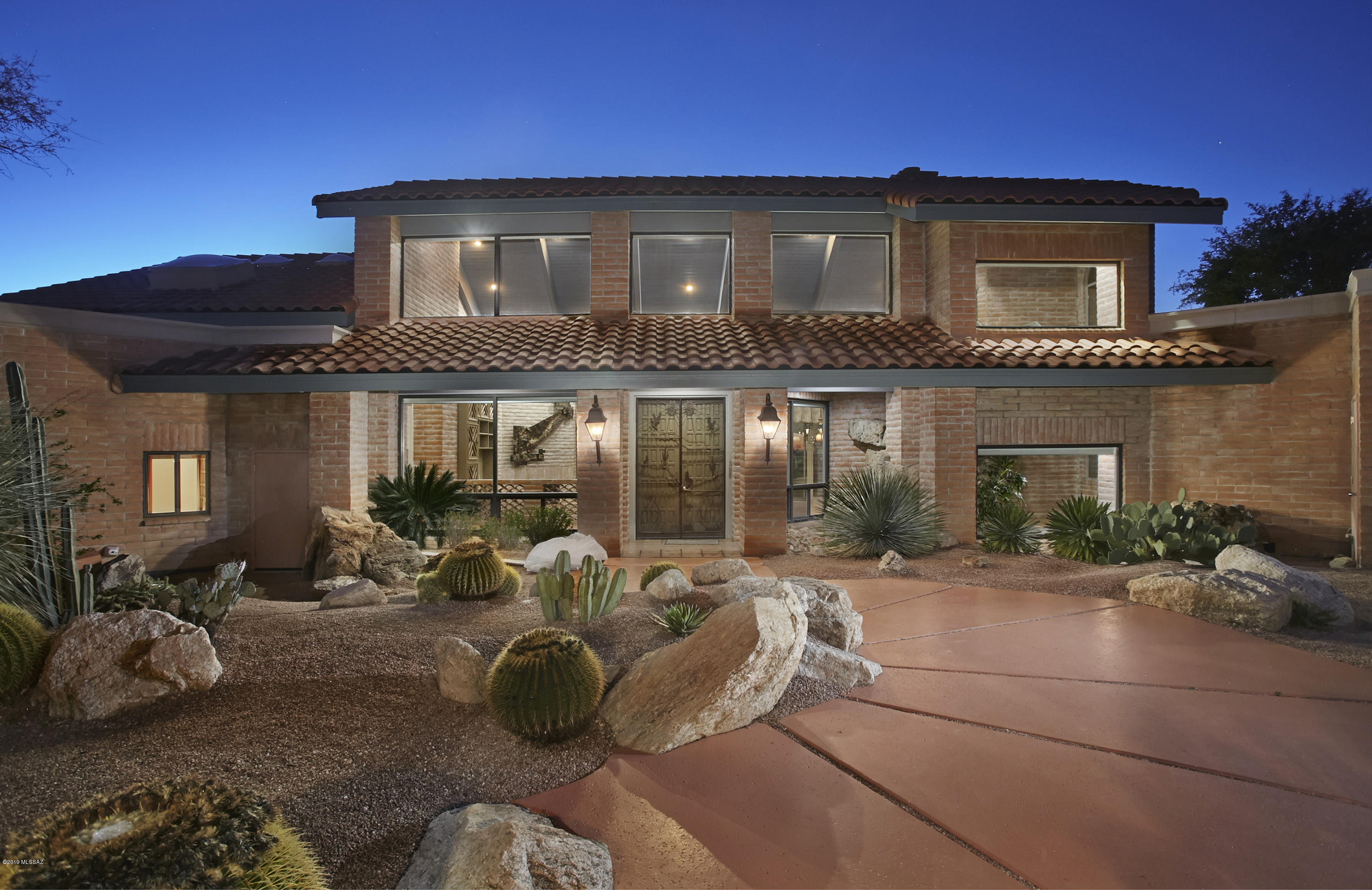Tucked away in the FAR REACHES of Tanque Verde Valley within gated, Redington Ranch Estates lies this 4,091 sqft, 3br, 5 ba Mission style home affording SWEEPING city lights and STUNNING eye-popping views SWOOPING thru canyons, hills and mountains.  DRONE VIDEO – click on Photos/Video. 2.6 acs w/ infinity acres BORDERING 480' of NATIONAL FOREST. Includes Guest Casita and TWO BONUS ROOMS, one w/ large viewing deck!  Entry through private, driveway gate that borders forest line to impeccable maintained front entry. High, SOARING, beamed ceilings &  walls of windows = abundance of natural light, outside-in feel. Striking copper sculpture ACCENUATES living area; EXPANSIVE saltillo tiled veranda runs length of home, overlooking pool and entire Tucson valley to glorious sunsets. METICULOUSLY MAINTAINED inside and out for 24 years.  Comfortable master wing, open living and dining rooms and kitchen with center island.   941 sqft GUEST CASITA boasts wood-burning fireplace, creating very homey feel. Community Clubhouse w/ on-site manager, kitchen, pool, horse stables/stalls, tennis court.  Quick easy access to thousands of acres of riding and hiking trails. Propane gas only to pool/sp