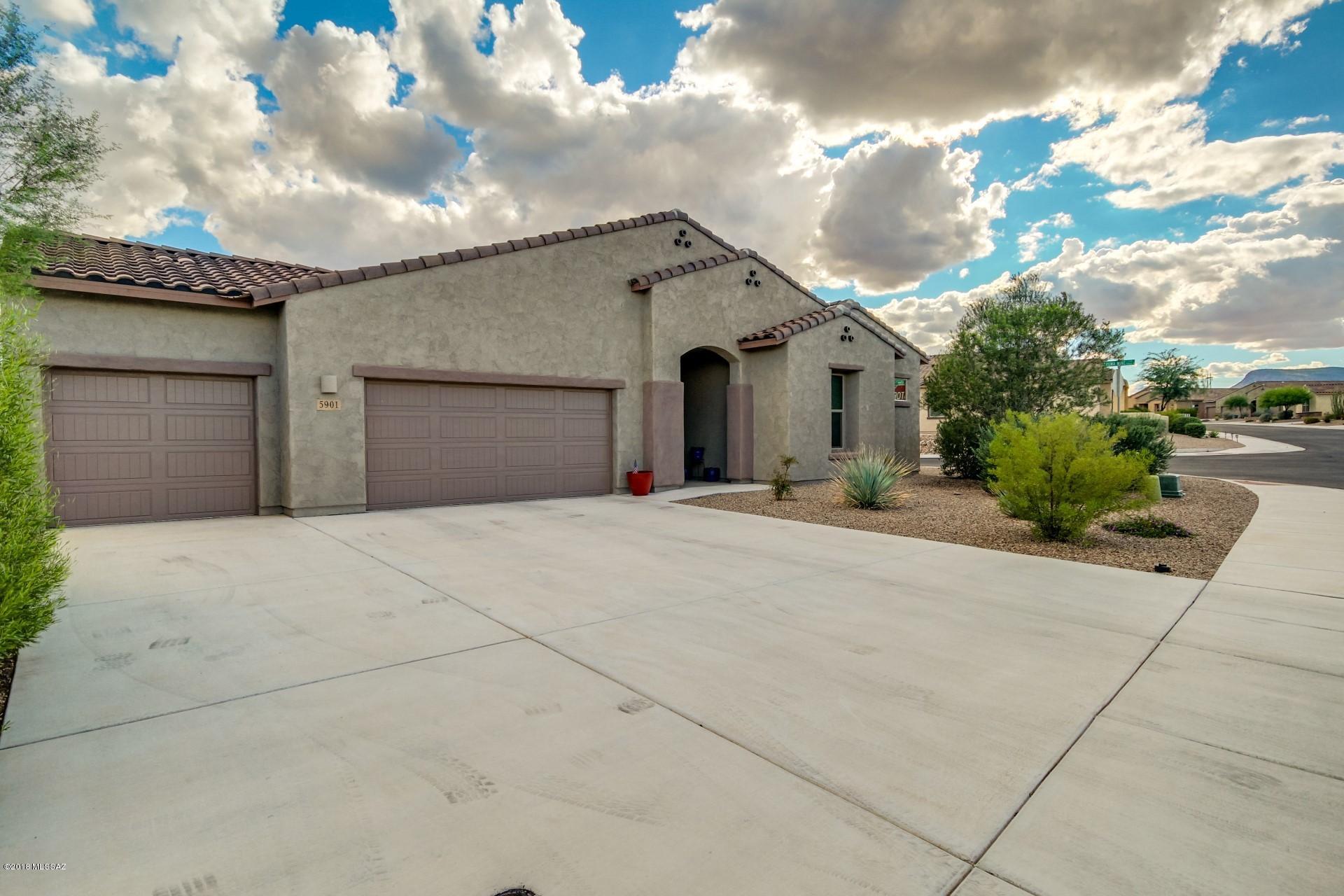 MUST SEE!! Don't miss this opportunity to impress your Buyer's by SHOWING this Silverbell BEAUTY. Pride of Ownership on this meticulously maintained home shines through. Homes in this Private Gated Community do not come on the market often.  This is a Split Great Room floor plan w/10 ft ceilings throughout featuring 4 bedrooms 3 baths plus a den, formal dining and a 3 car Garage on a LARGE 11,326 Corner Lot with a North South Exposure. The Kitchen is a Chef's dream with a SS KithenAid Appliance package featuring a Double in wall oven, separate Cook-top w/gas option and Granite Countertops. Tastefully appointed Upgrades Throughout include tile in Great Room, Formal Dining Area, Bathrooms and in all traffic areas. The Master Bathroom has Granite Countertops, separate large soaking tub, tiled shower, double sinks with a large master closet w/Cal Closet Built-ins.The home is equipped with fire sprinklers, whole house water softener, prewired for Audio, Ceiling fans installed throughout and is "Energy Efficient" The backyard is an Entertainers Delight with Beautiful Mountain Views, professionally landscaped, large covered patio, Gorgeous solar and gas heated Salt Water Pebble Tec Pool w/in floor cleaning system, slide, waterfall and Grotto. Drip irrigation system to plants, Synthetic grass, all very low maintenance.  Ideal location close to shopping, dining, entertainment. Walking distance to Award-Winning Leman Academy School, Library and Crossroads District Park. New Ina Intersection allows for easy on/off freeway access. Entry to "The Loop" 110 mile paved bike trail system is less than 1 mile away! Refrigerator, Washer, Dryer and Some Furnishings may convey on a separate bill of sale. THIS HOME IS A MUST SEE!!!