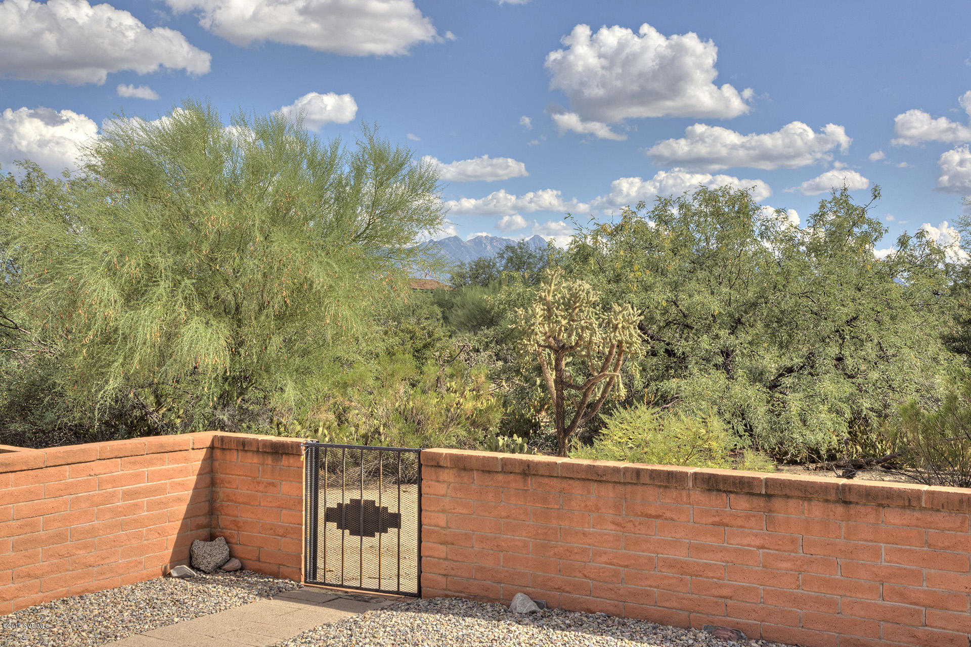 This clean, well maintained Townhome has one of the best locations in the community w/ desert and mountain views. No homes behind and great privacy. With a southern exposure and completely furnished, it is perfect for winter visitors. MBR has direct access to the private patio. Guest BR looks out to front courtyard. It is vintage 70's but in great shape. A huge covered patio looking out to the natural desert with mature trees and mountains beyond is perfect for relaxation. Low association fees and GVR pool is right down the street.