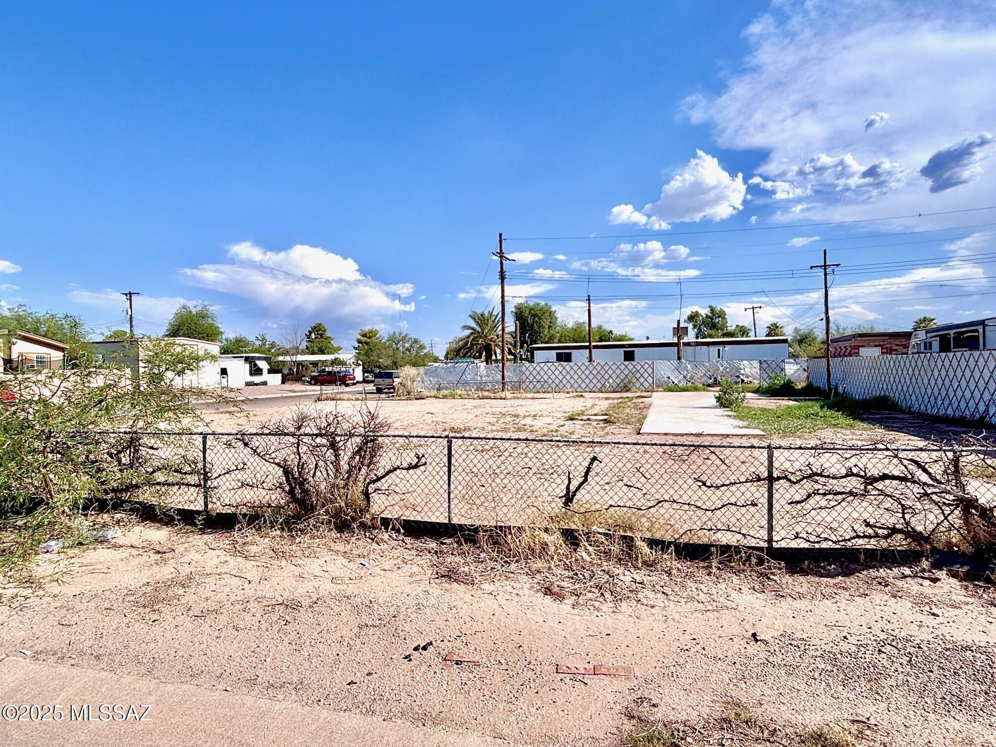 Graded Corner lot with 16ft alley behind! Sidewalk and fence wrap around the lot. There's a mountain view when looking NE! Formerly developed - that means utilities are within or to the lot line! Located at the corner of Palmyra & Papaya, in the heart of the Flowing Wells District. EZ access to I-10, downtown Tucson! One of the last affordable areas where you can bring a new or used mobile or manufactured home and set it up for a carefree & budget-friendly life!  NO HOA! The lot is flat, graded & ready!