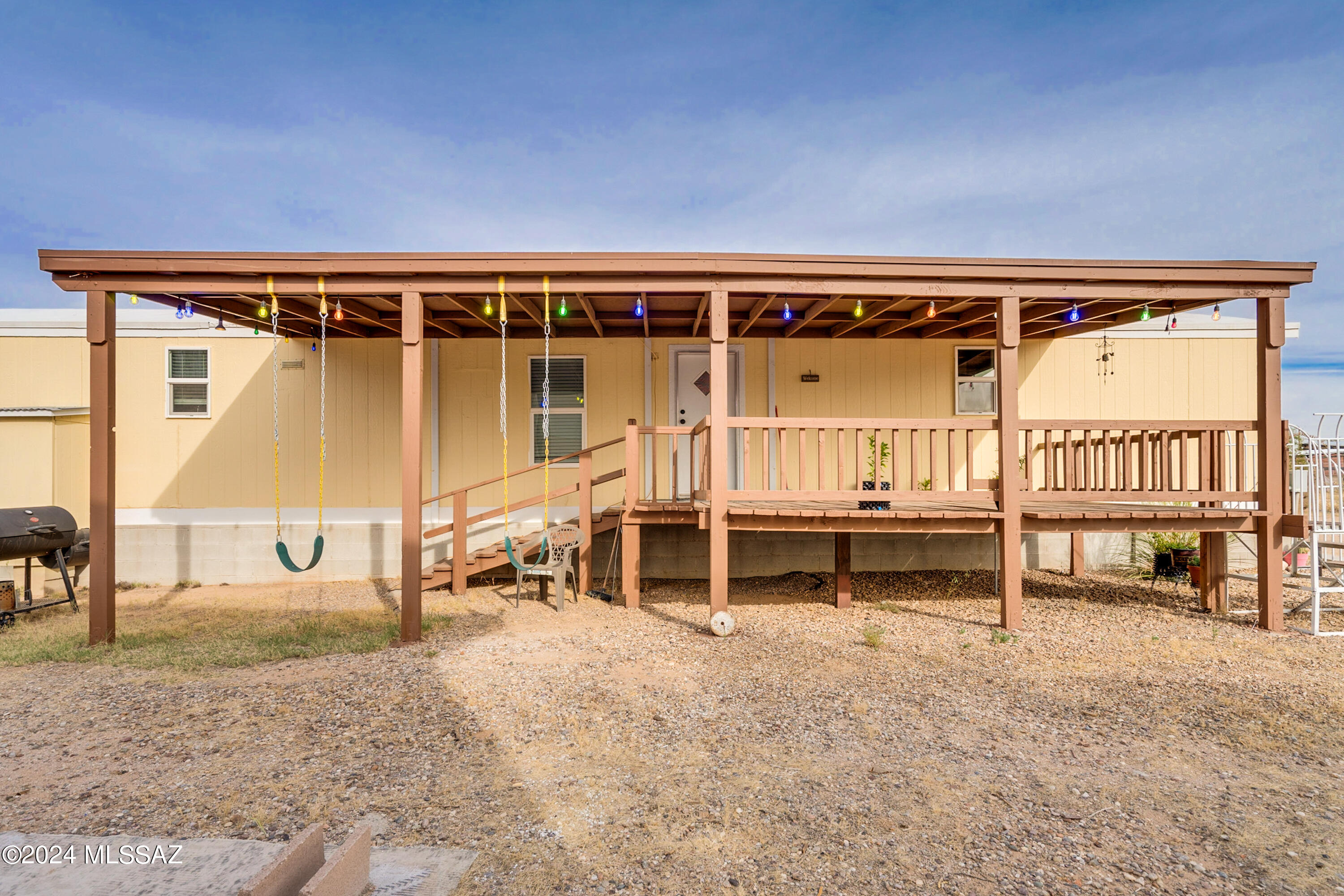 This is a must-see!  3 bed, 2 bath, plus a guest house, 2 covered porches, fully fenced 1- acre lot w/ 2 rolling gates ready for your pets, horses & other animals. The main home has been meticulously maintained.  The exterior has been recently painted. New 50 gal. 5500 watt water heater.  Living room flows seamlessly into the kitchen, which features a gas range w/ ample cabinets & counter space.  The split bedroom plan ensures privacy w/ the primary bedroom has 2 walk-in closets. Walk upstairs to see the stunning guest house which boasts of both Italian & Tuscan tile.  It has a mini kitchen, full bath & balcony.  Step outside onto the balcony to enjoy breathtaking mountain & sunset views.  Home is near a school, a park which has a pool, & a BMX skate park. 65'' and 58'' TV's included.
