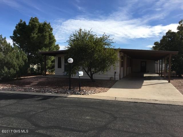 Cute, easy care 2 bdrm 2 bath home with AZ Room. Inside laundry with newer washer & dryer. Large fenced back yard. Storage/workshop. 2 Car covered parking. Covered rear patio with Mountain views. Updated wood look flooring in kitchen,living room and master bedroom. New carpet in guest bedroom. Guest bath and hallway w/new flooring. New roof on carport & storage workshop. Newer Heating/Cooling unit, refrigerator and dishwasher. HOA includes trash pickup, RV Storage if available,Heated pool & spa, exercise, billiards,library!
 Don't Miss This Great Home Great Buy!
