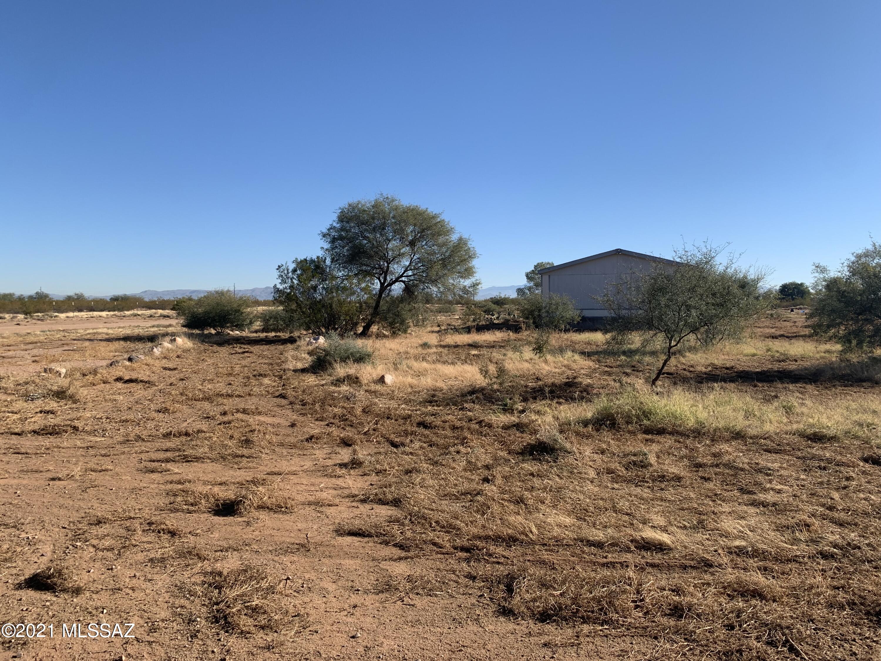 Great piece of property with lots of potential. Power, Septic, and Shared Well and fully fenced! 1997 Affixed manufactured home needs serious work or replacing. Concrete slab with power previously had a large shop, permit shows an AG Barn.