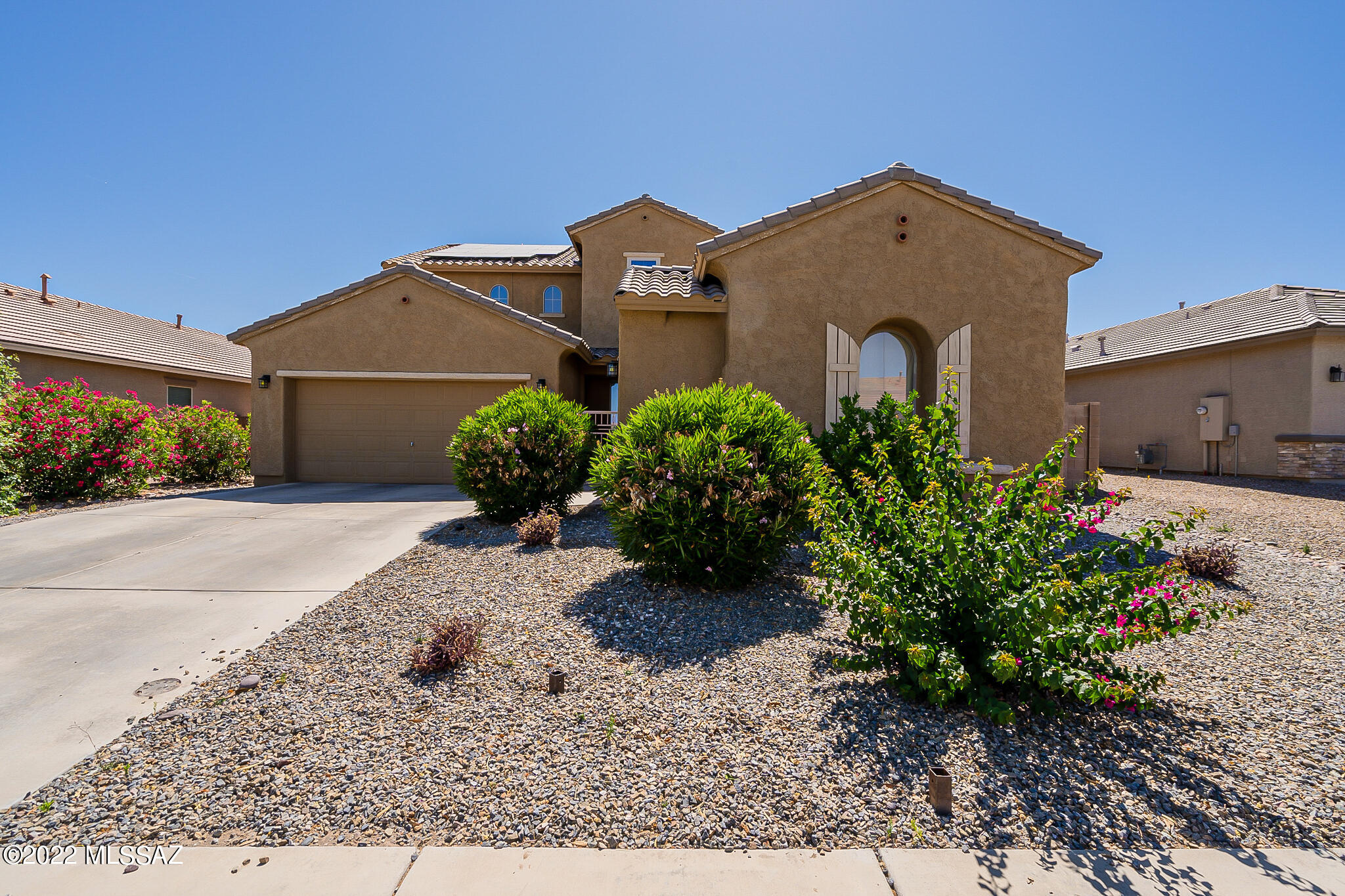 Welcome to this beautiful, Contemporary Gladden Farms Home! Grand entry foyer welcomes you to this spacious 4 bedroom + a den home! Light & bright throughout with soaring cathedral ceilings and an easy flowing, open floor plan! Ceramic tile flooring with inlaid decorator tile accents. Upgraded kitchen features stainless appliances, beautiful wood cabinetry and granite countertops plus a large walk-in pantry/storage room. Downstairs features large great room perfect for entertaining and also a formal living area with plenty of space for the family to spread out and enjoy, full bathroom downstairs is a plus!  Upstairs features large Master suite w/ light-filled master bath, dual sinks, garden tub, walk-in shower & vanity area, and a split bedroom plan w/ three additional bedrooms share a large bathroom.  No neighbors behind allows for  great mountain views and lots of privacy.   Owned solar system is powering this home, along with all new windows and doors keeps you saving tons of money on Electricity all year long!