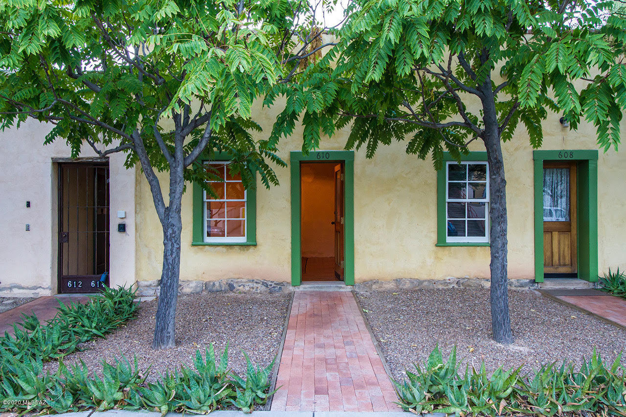 Perfect historic birdnest in Tucson's oldest barrio:  Barrio Viejo.  Built in 1890 and meticulously restored by renowned barrio builder, gorgeous end unit with lots of light,  22'' thick adobe walls and 12' ceilings crafted of hand hewn beams and victorian packing crates. Floors are brick and scored concrete. Additional delightful details are the skylights and renovated kitchen and bath.  This owner updated the home with upper-end stainless appliances, and newer washer and dryer.  The shaded inner courtyard is a private oasis with grand mesquite trees.  This is a Tucson landmark rich with history, a true barrio retreat.   There is one off street parking spot for each home in the parking lot for the community. Walk to 5 Pts shops and cafes, and all that downtown Tucson has to offer!